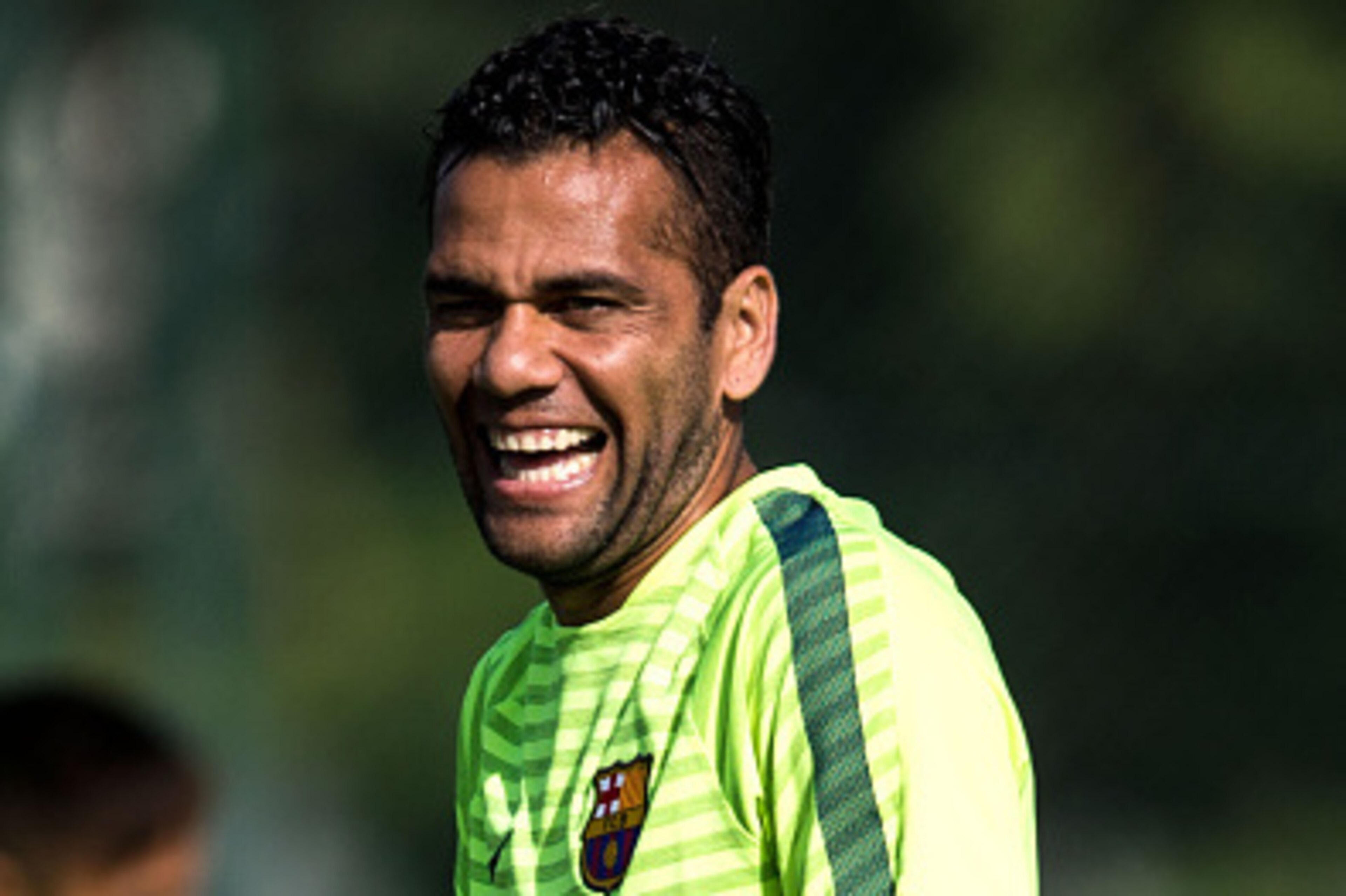 BARCELONA, SPAIN - OCTOBER 20:  Dani Alves of FC Barcelona smiles during a training session ahead of their UEFA Champions League Group F match against AFC Ajax at Ciutat Esportiva on October 20, 2014 in Barcelona, Spain.  (Photo by David Ramos/Getty Image