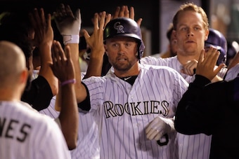 DENVER, CO - SEPTEMBER 19:  Michael Cuddyer #3 of the Colorado Rockies celebrates his grand slam home run of of Eury De La Rosa #56 of the Arizona Diamondbacks to give the Rockies a 11-2 lead in the sixth inning at Coors Field on September 19, 2014 in Den