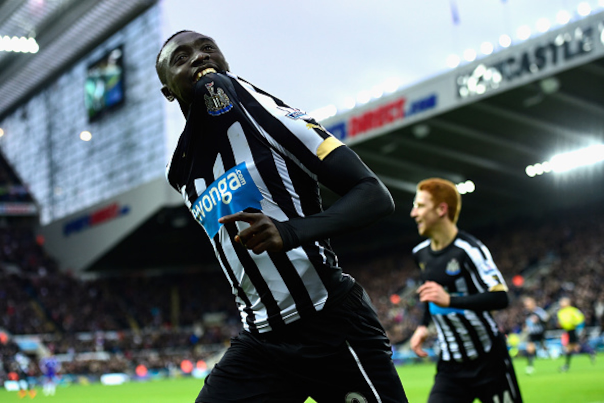 NEWCASTLE UPON TYNE, ENGLAND - DECEMBER 06:  Papiss Cisse of Newcastle (r) celebrates after scoring the opening goal during the Barclays Premier League match between Newcastle United and Chelsea at St James' Park on December 6, 2014 in Newcastle upon Tyne