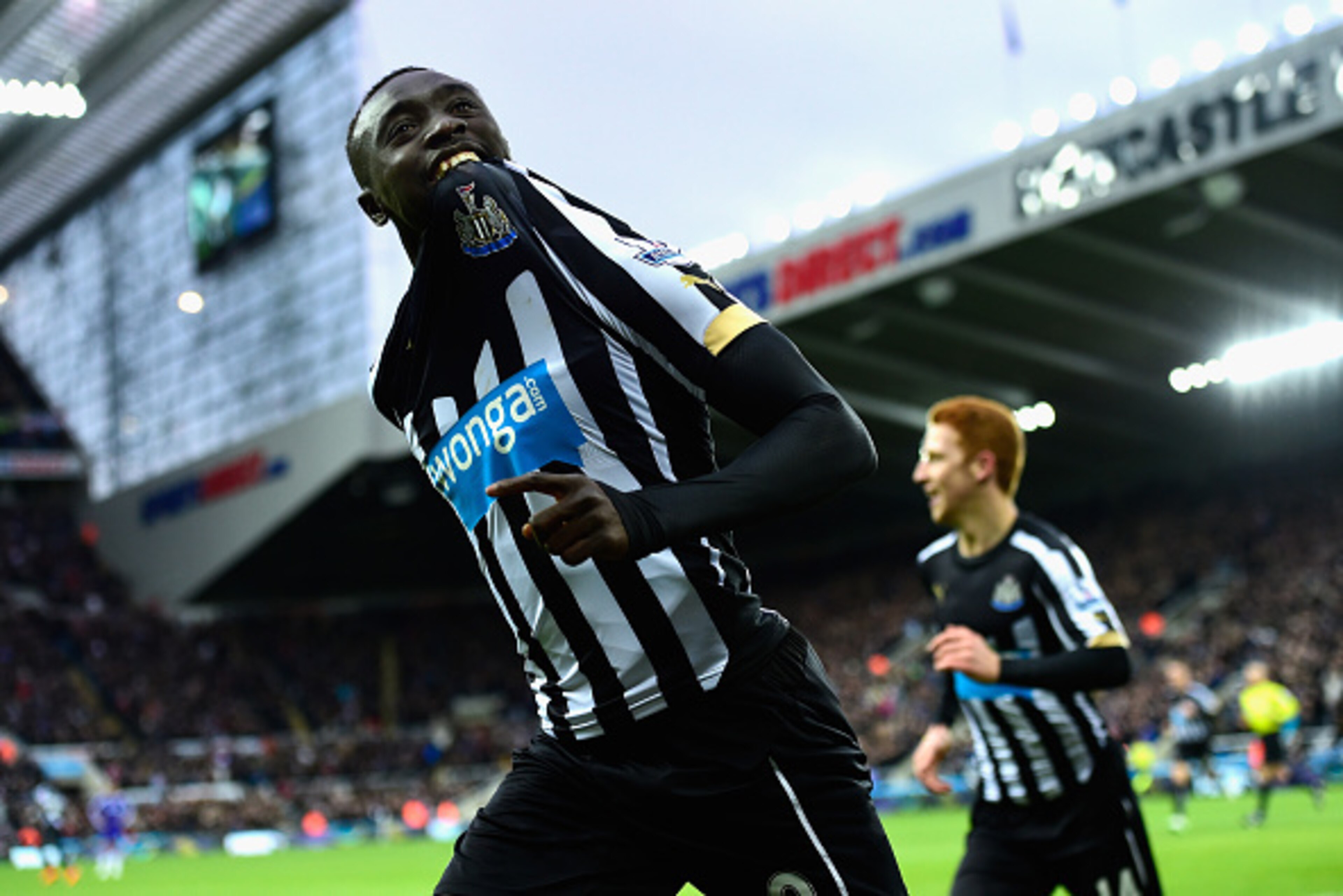 NEWCASTLE UPON TYNE, ENGLAND - DECEMBER 06:  Papiss Cisse of Newcastle (r) celebrates after scoring the opening goal during the Barclays Premier League match between Newcastle United and Chelsea at St James' Park on December 6, 2014 in Newcastle upon Tyne