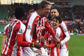 STOKE ON TRENT, ENGLAND - DECEMBER 06:  Peter Crouch of Stoke City celebrates scoring the opening goal with his team-mates during the Barclays Premier League match between Stoke City and Arsenal  at the Britannia Stadium on December 6, 2014 in Stoke on Tr