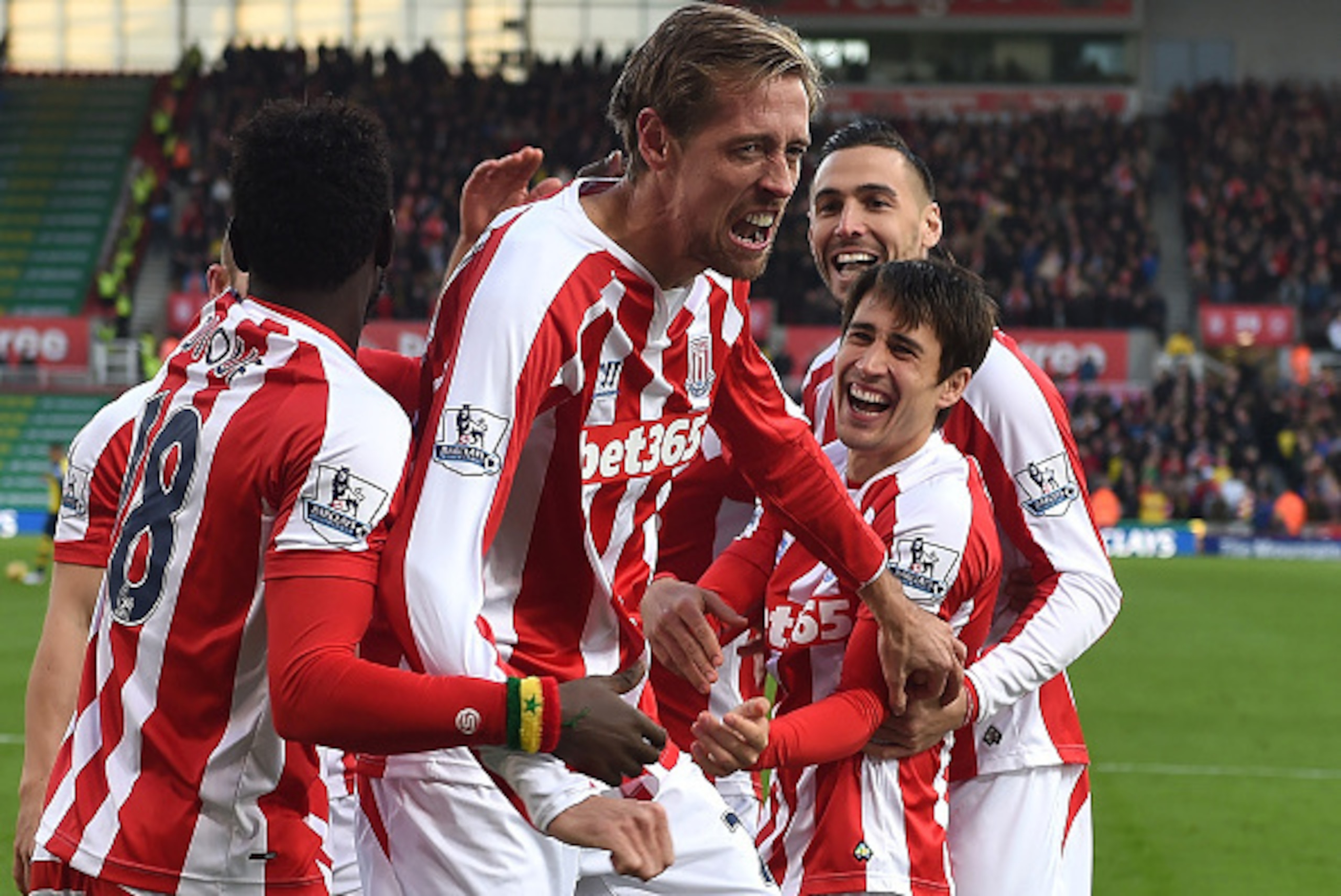 STOKE ON TRENT, ENGLAND - DECEMBER 06:  Peter Crouch of Stoke City celebrates scoring the opening goal with his team-mates during the Barclays Premier League match between Stoke City and Arsenal  at the Britannia Stadium on December 6, 2014 in Stoke on Tr