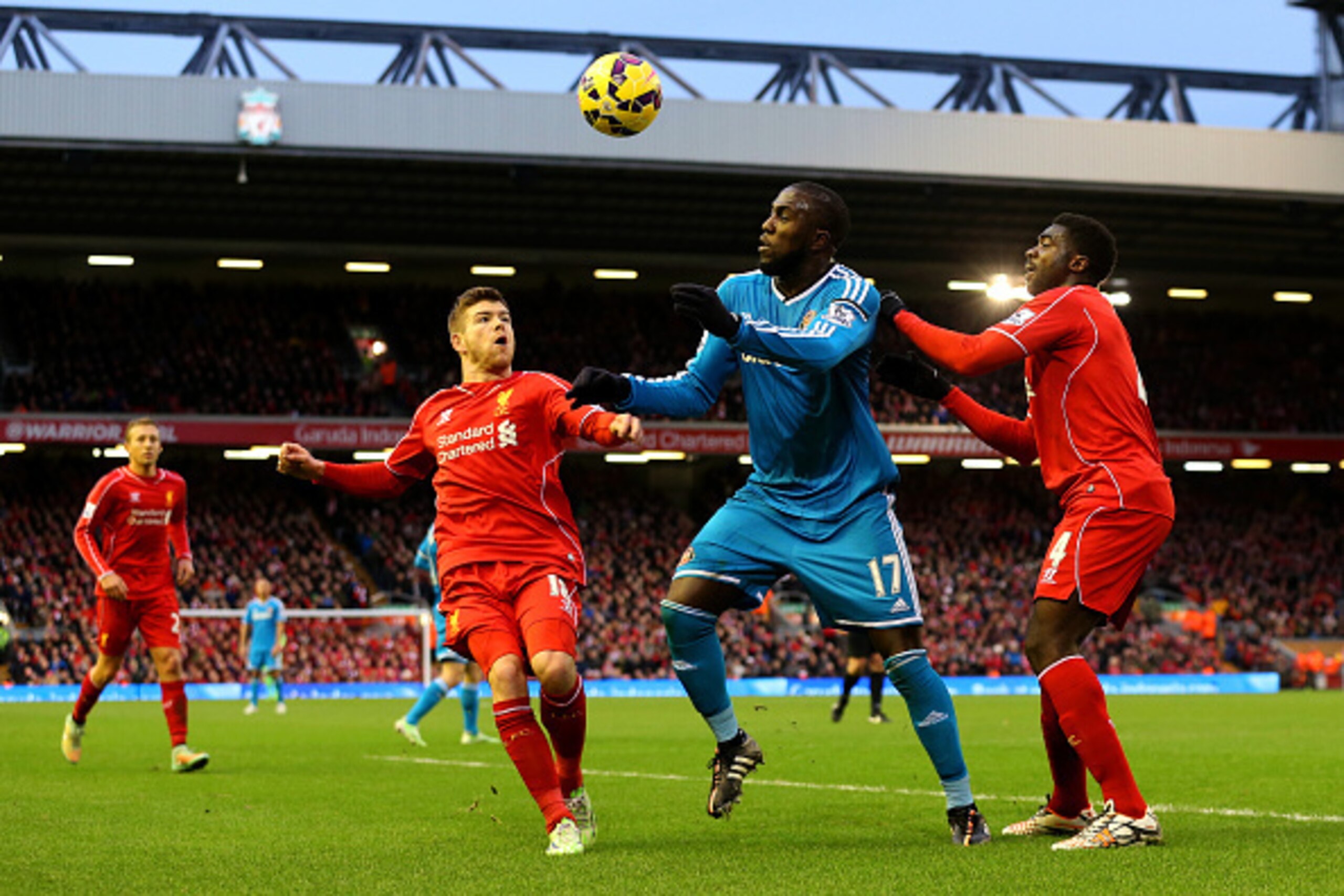 LIVERPOOL, ENGLAND - DECEMBER 06:  Jozy Altidore of Sunderland battles for the ball with Kolo Toure and Alberto Moreno of Liverpool during the Barclays Premier League match between Liverpool and Sunderland at Anfield on December 6, 2014 in Liverpool, Engl