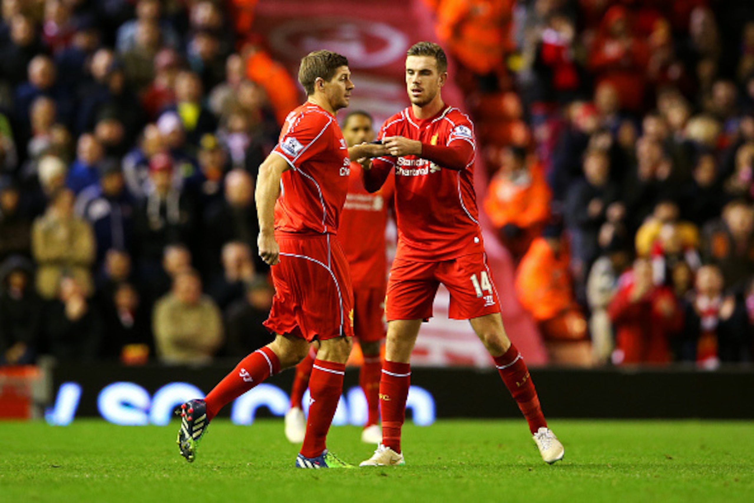 LIVERPOOL, ENGLAND - DECEMBER 06:  Jordan Henderson of Liverpool hands the captain's armband over to Steven Gerrard of Liverpool as he comes on to the field during the Barclays Premier League match between Liverpool and Sunderland at Anfield on December 6