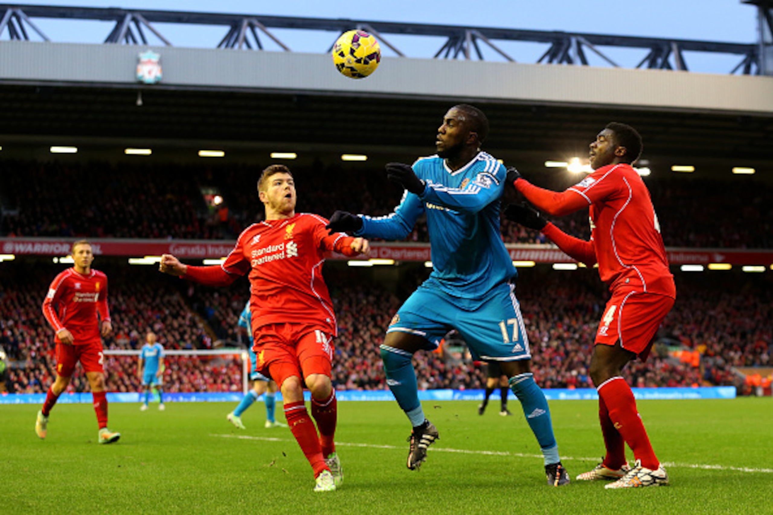 LIVERPOOL, ENGLAND - DECEMBER 06:  Jozy Altidore of Sunderland battles for the ball with Kolo Toure and Alberto Moreno of Liverpool during the Barclays Premier League match between Liverpool and Sunderland at Anfield on December 6, 2014 in Liverpool, Engl