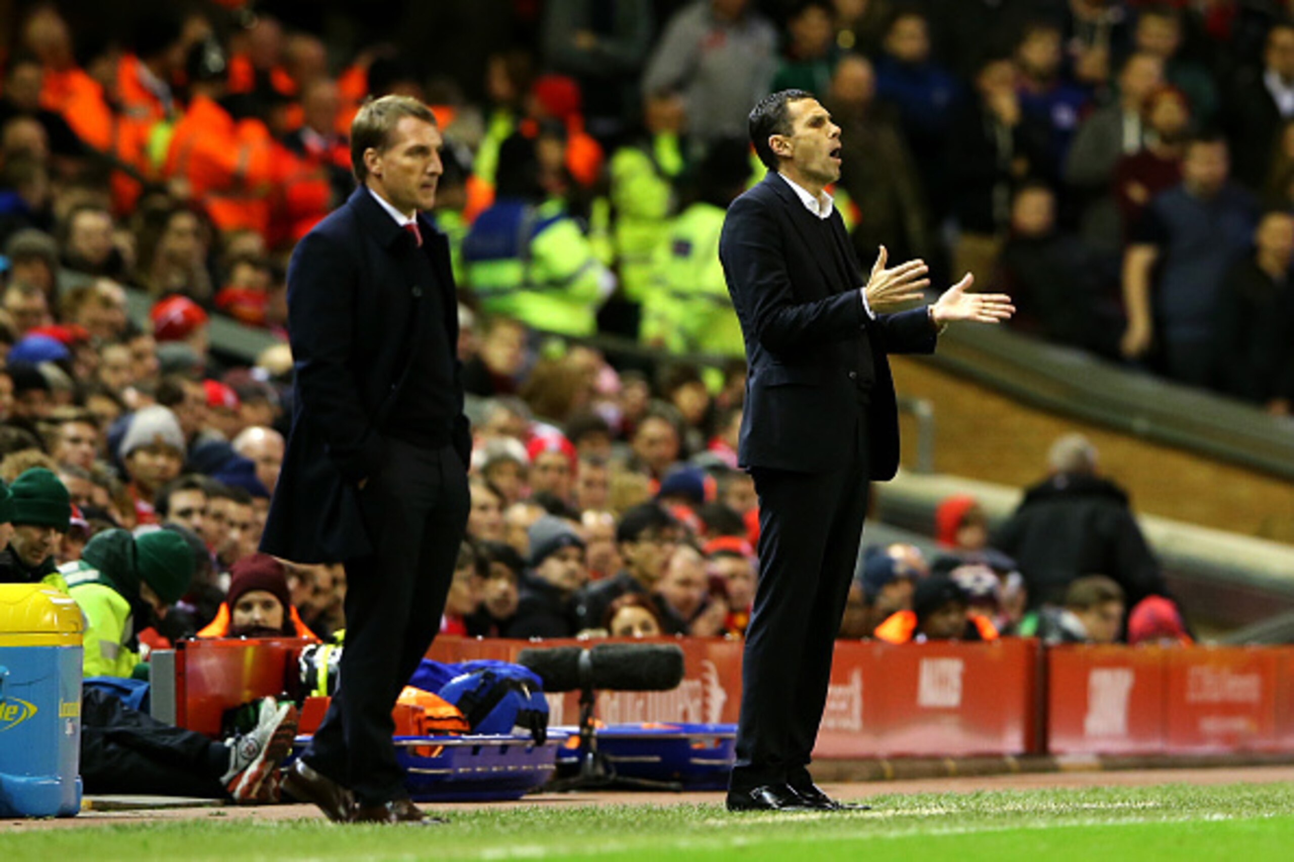 LIVERPOOL, ENGLAND - DECEMBER 06:  Manager Gustavo Poyet of Sunderland reacts next to Brendan Rodgers, manager of Liverpool during the Barclays Premier League match between Liverpool and Sunderland at Anfield on December 6, 2014 in Liverpool, England.  (P