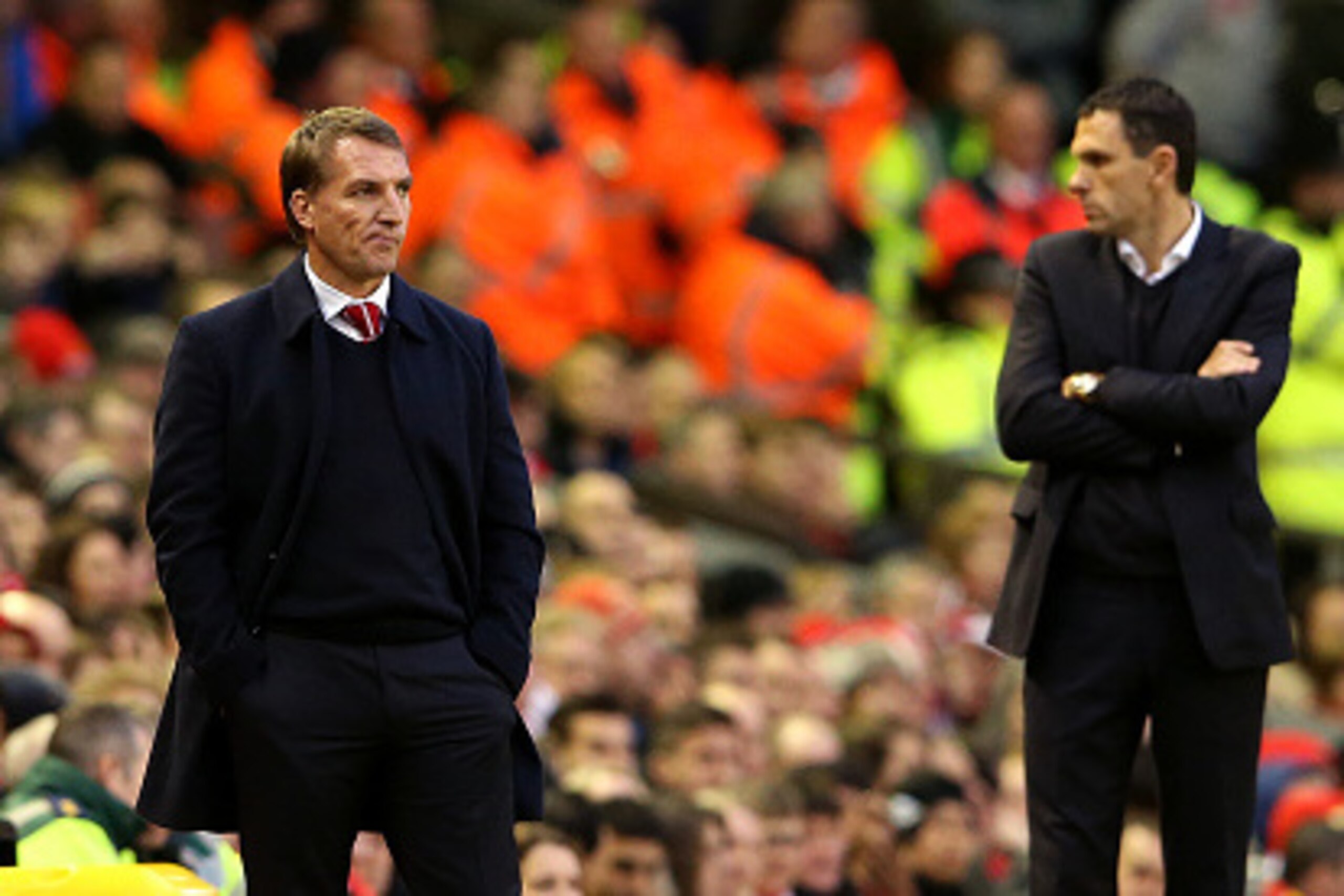 LIVERPOOL, ENGLAND - DECEMBER 06:  Brendan Rodgers, manager of Liverpool looks on next to Gustavo Poyet, manager of Sunderland during the Barclays Premier League match between Liverpool and Sunderland at Anfield on December 6, 2014 in Liverpool, England. 