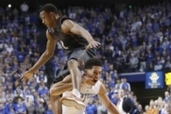 Dec 5, 2014; Lexington, KY, USA; Kentucky Wildcats guard Devin Booker (1) dribbles the ball under Texas Longhorns guard Demarcus Holland (2) in the second half at Rupp Arena. Kentucky defeated Texas 63-51. Mandatory Credit: Mark Zerof-USA TODAY Sports