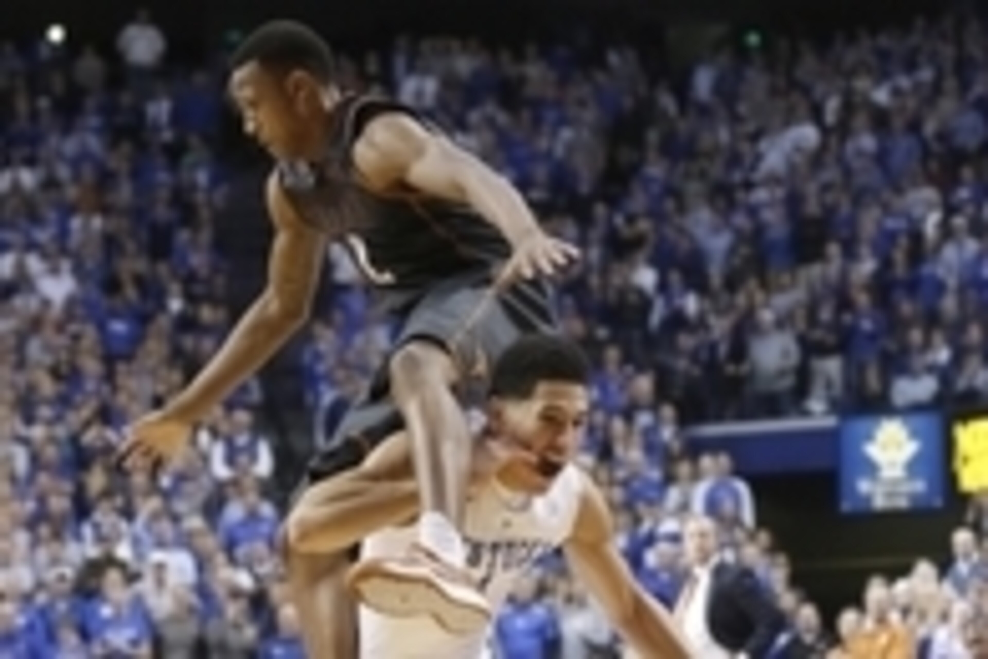 Dec 5, 2014; Lexington, KY, USA; Kentucky Wildcats guard Devin Booker (1) dribbles the ball under Texas Longhorns guard Demarcus Holland (2) in the second half at Rupp Arena. Kentucky defeated Texas 63-51. Mandatory Credit: Mark Zerof-USA TODAY Sports