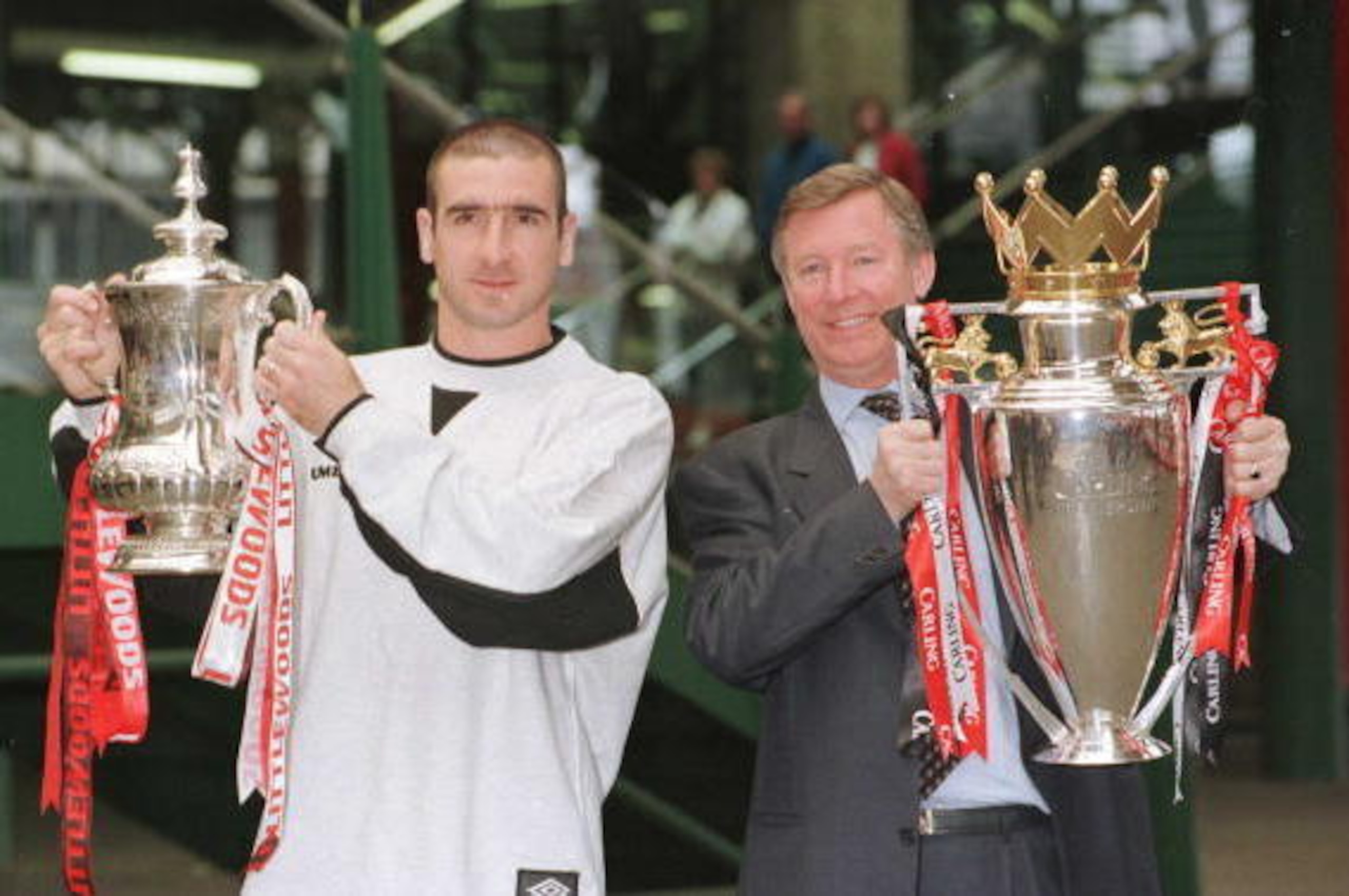 12th May 1996; Manchester United manager Alex Ferguson and Eric Cantona with the FA Cup and Premiership trophy on their arrival at Manchester's Victoria station. Mandatory Credit: Shaun Botterill/ALLSPORT 12th May 1996; Manchester United manager Alex Ferguson and Eric Cantona with the FA Cup and Premiership trophy on their arrival at Manchester's Victoria station. Mandatory Credit: Shaun Botterill/ALLSPORT