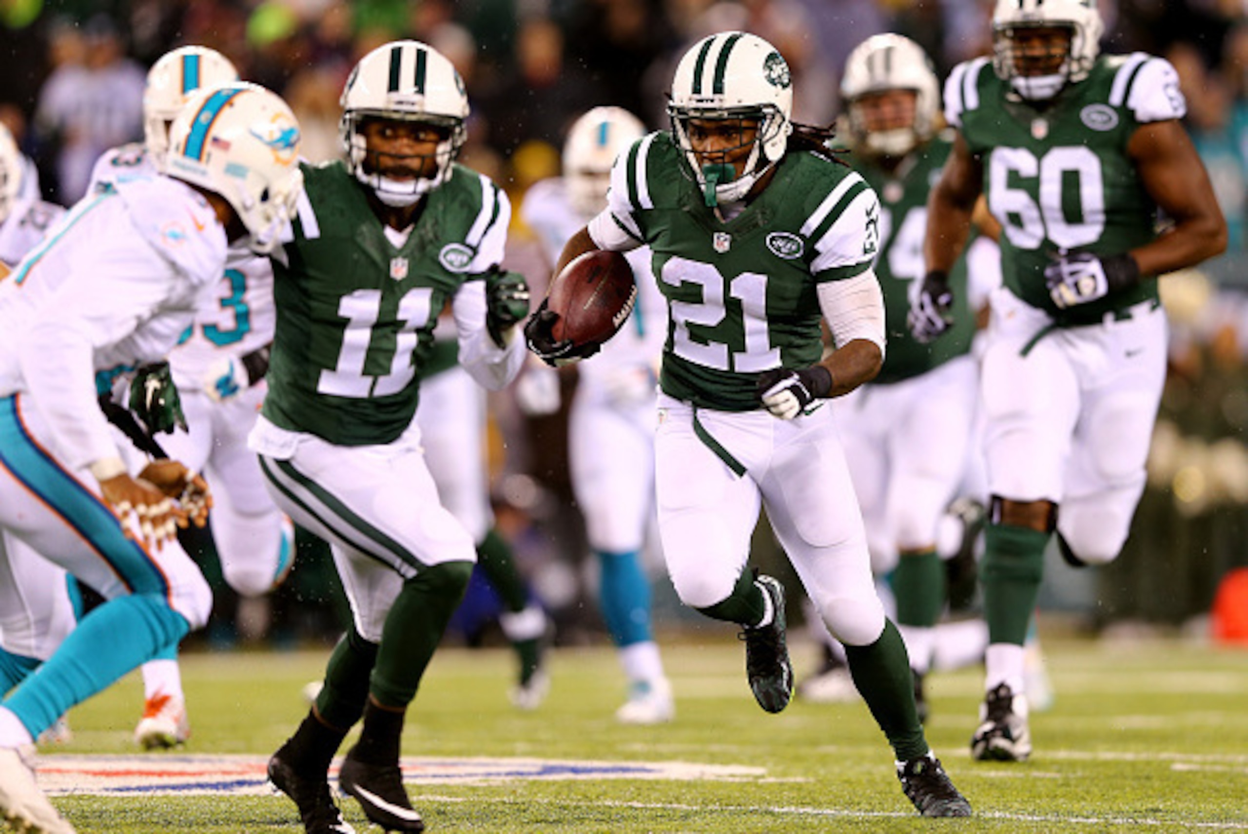EAST RUTHERFORD, NJ - DECEMBER 01:  Chris Johnson #21 of the New York Jets runs the ball in the first quarter against Miami Dolphins during their game at MetLife Stadium on December 1, 2014 in East Rutherford, New Jersey.  (Photo by Elsa/Getty Images)