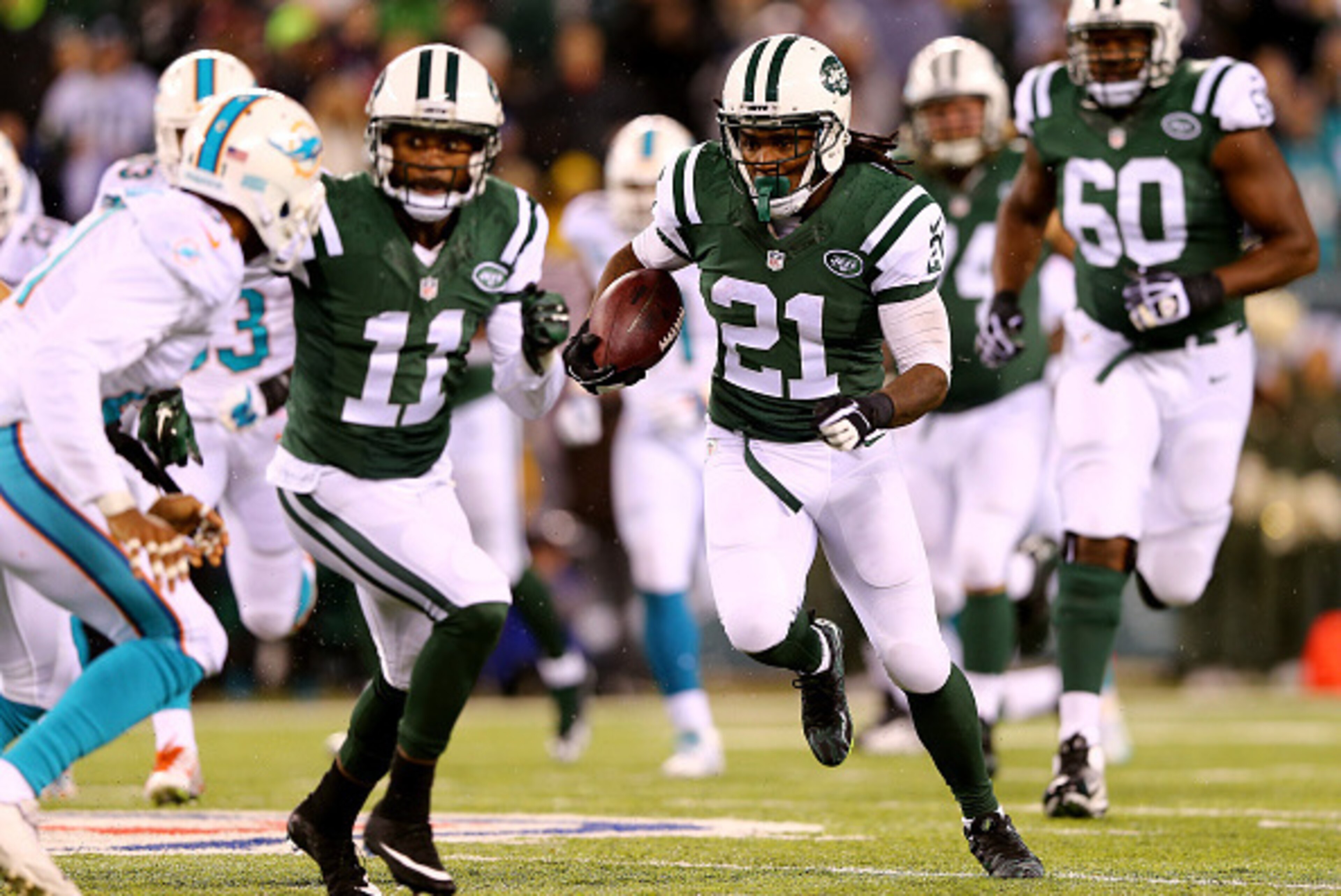 EAST RUTHERFORD, NJ - DECEMBER 01:  Chris Johnson #21 of the New York Jets runs the ball in the first quarter against Miami Dolphins during their game at MetLife Stadium on December 1, 2014 in East Rutherford, New Jersey.  (Photo by Elsa/Getty Images)