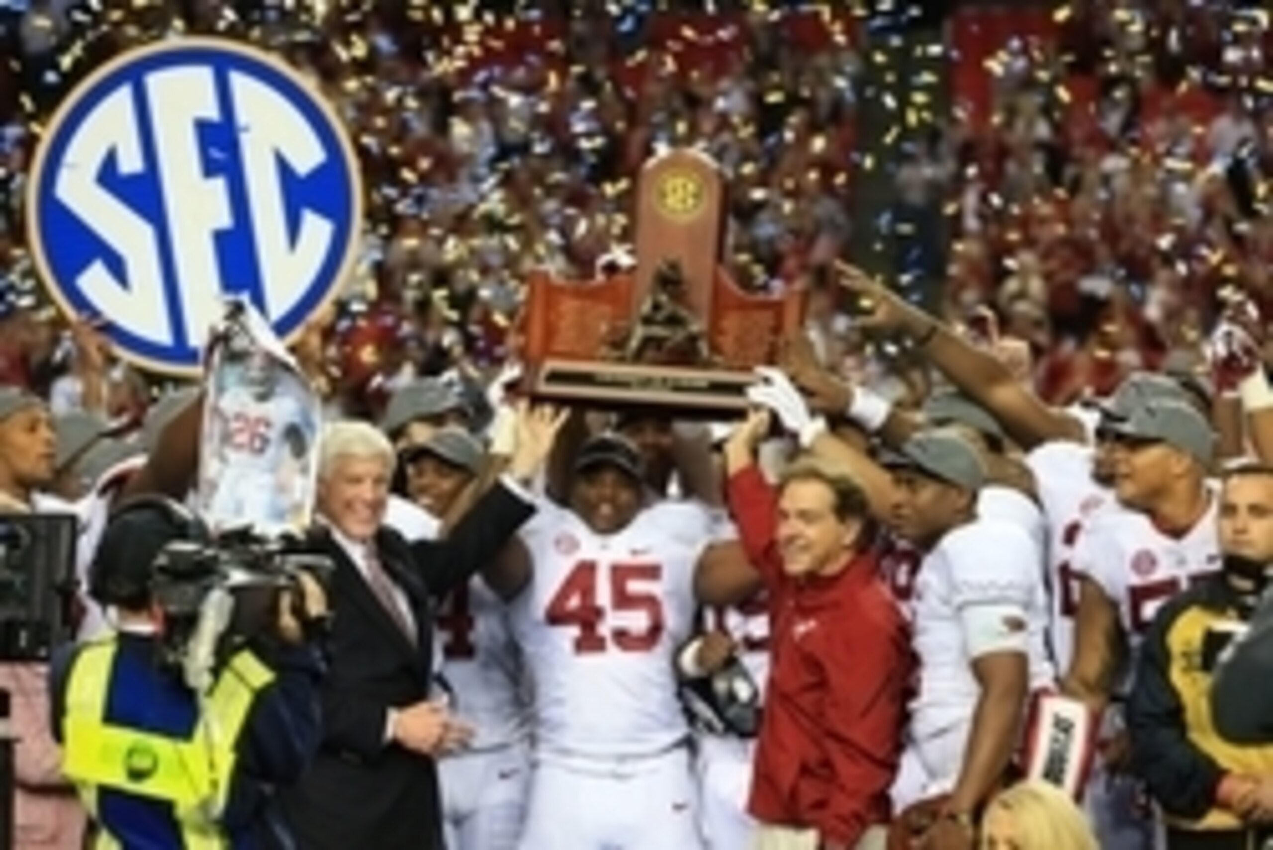 Dec 6, 2014; Atlanta, GA, USA; Alabama Crimson Tide head coach Nick Saban and his team celebrate with the trophy after the 2014 SEC Championship Game against the Missouri Tigers at the Georgia Dome. Alabama defeated Missouri 42-13. Mandatory Credit: Kevin