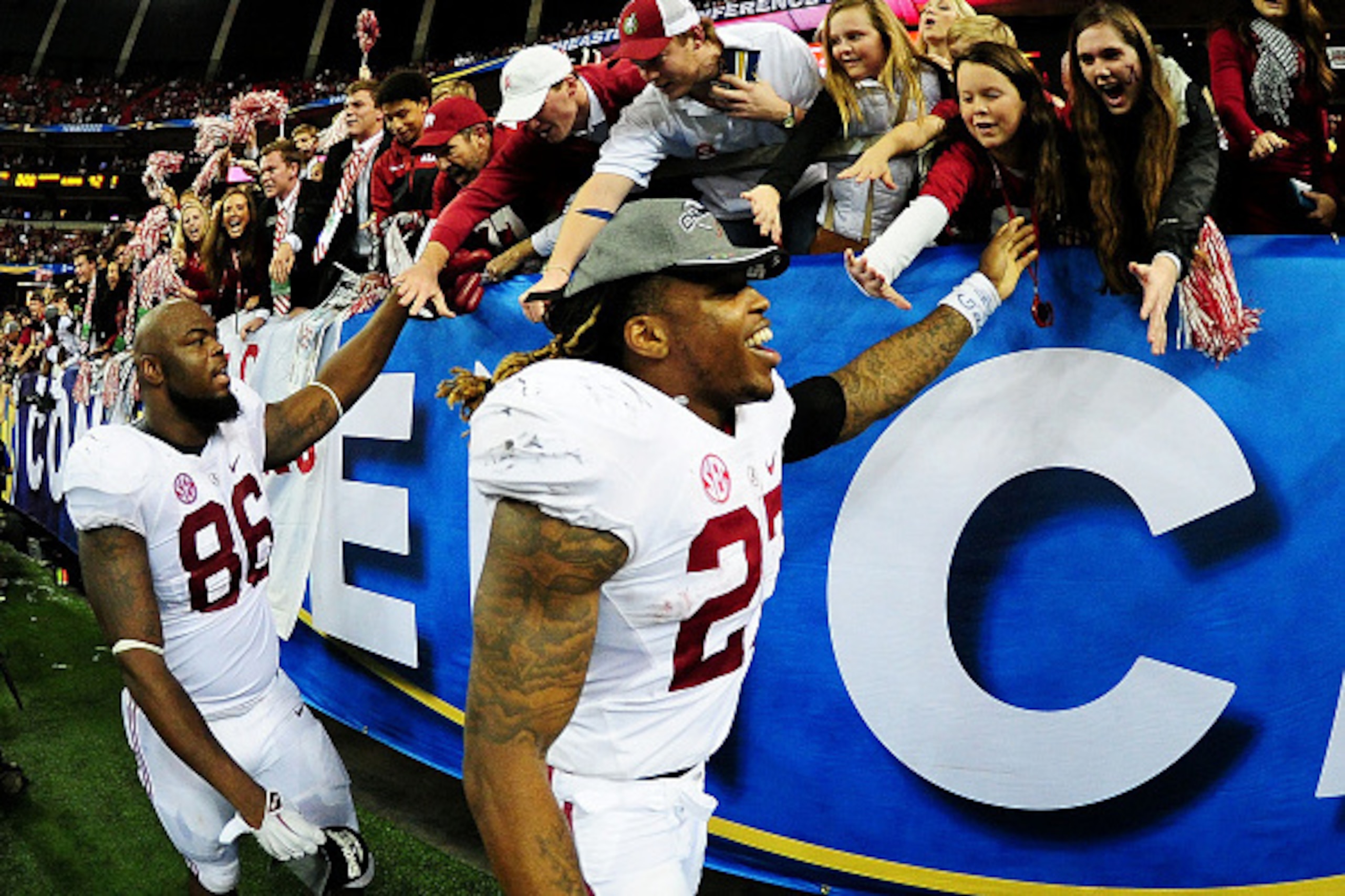 ATLANTA, GA - DECEMBER 06:  Derrick Henry #27 of the Alabama Crimson Tide celebrates their 42 to 13 win over the Missouri Tigers in the SEC Championship game with fans at the Georgia Dome on December 6, 2014 in Atlanta, Georgia.  (Photo by Scott Cunningha