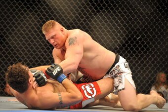 LAS VEGAS - JULY 11:  Brock Lesnar holds down Frank Mir during their heavyweight title bout during UFC 100 on July 11, 2009 in Las Vegas, Nevada. Lesnar defeated Mir by a second round knockout.  (Photo by Jon Kopaloff/Getty Images)