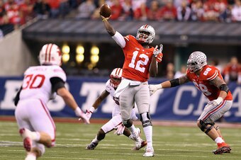 INDIANAPOLIS, IN - DECEMBER 06:  Quarterback Cardale Jones #12 of the Ohio State Buckeyes passes from the pocket during the third quarter against the Wisconsin Badgers in the Big Ten Championship at Lucas Oil Stadium on December 6, 2014 in Indianapolis, I