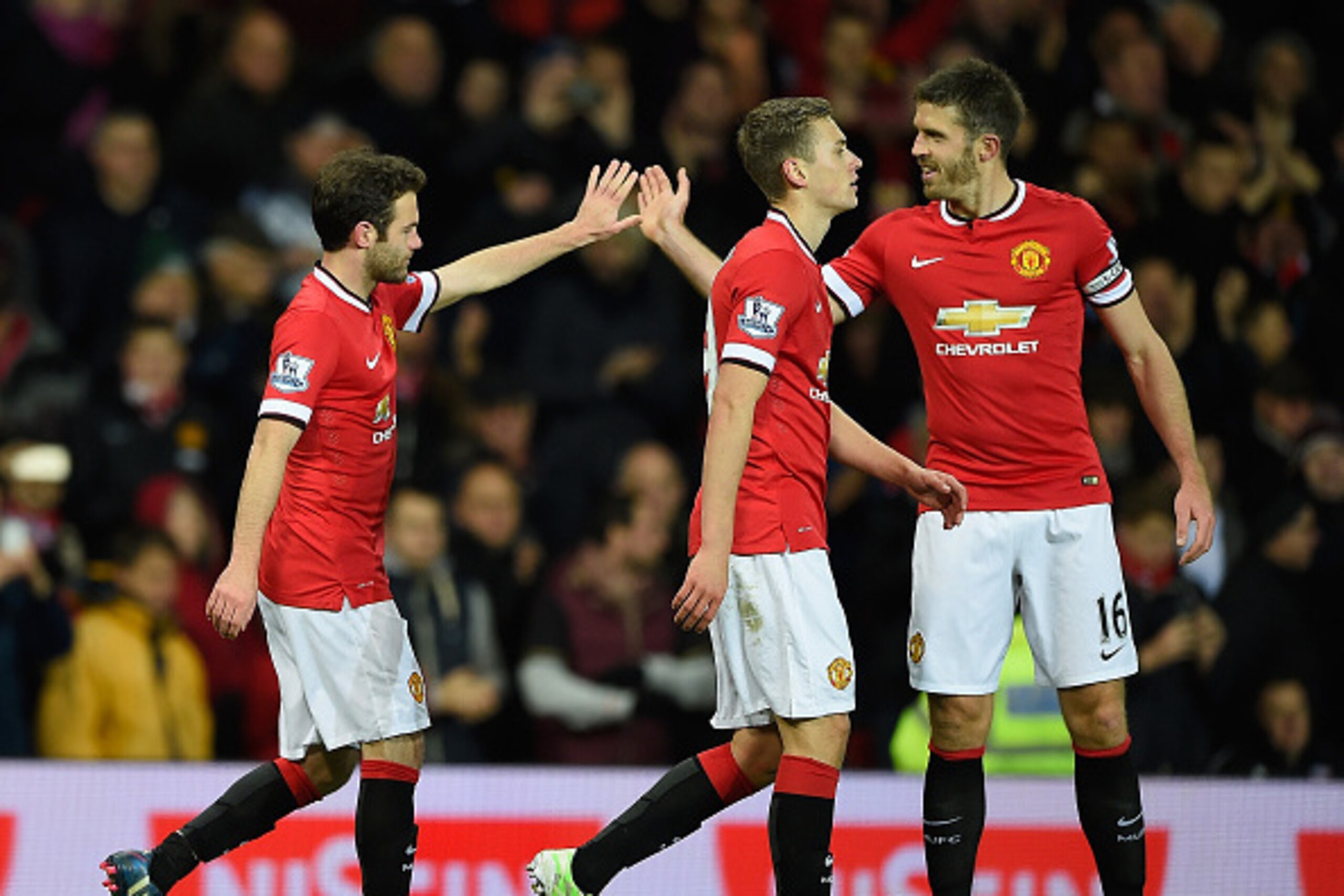 MANCHESTER, ENGLAND - DECEMBER 02:  Juan Mata of Manchester United (L) celebrates scoring his team's second goal with his team-mate Michael Carrick (R) during the Barclays Premier League match between Manchester United and Stoke City at Old Trafford on De