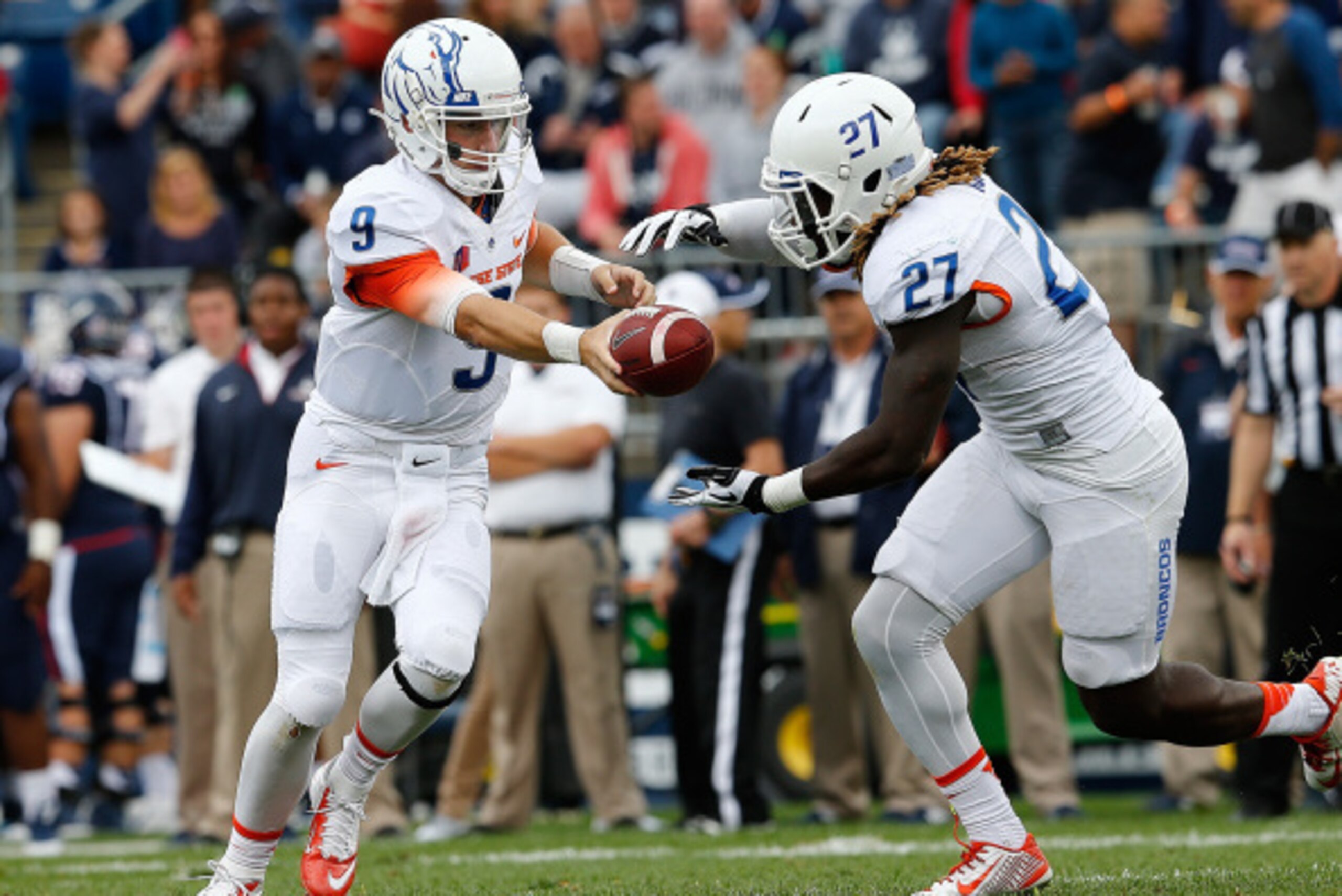 BOSTON, MA - SEPTEMBER 13:   Grant Hedrick #9 of the Boise State Broncos hands the ball to running back Jay Ajayi #27 in the first quarter  against the Connecticut Huskies at Rentschler Field on September 13, 2014 in East Hartford, Connecticut. (Photo by