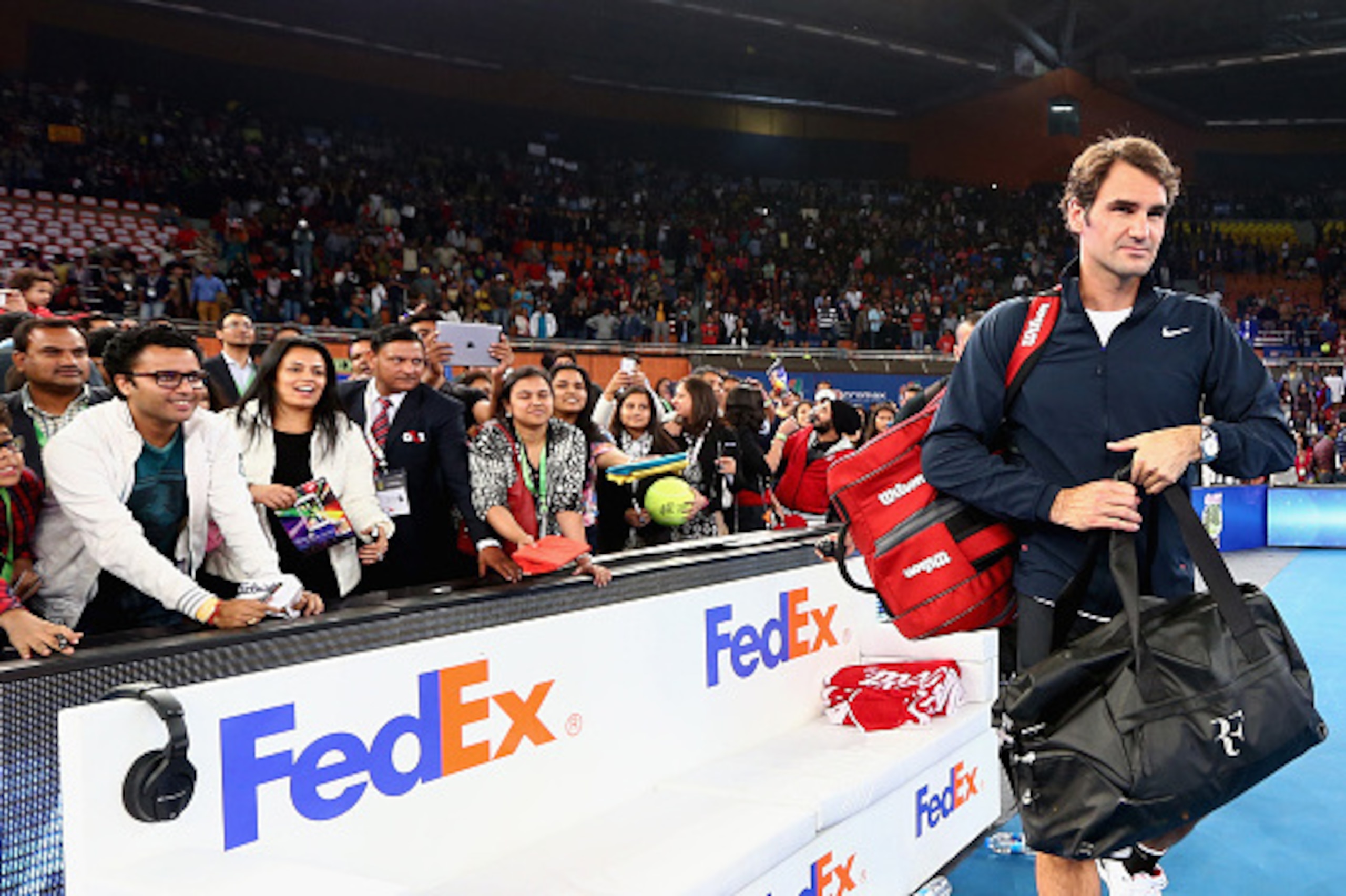 DELHI, INDIA - DECEMBER 07:  Roger Federer of the Indian Aces walks off the court after his victory in his match against Tomas Berdych  of the Singapore Slammers during the Coca-Cola International Premier Tennis League third leg at the Indira Gandhi Indoo