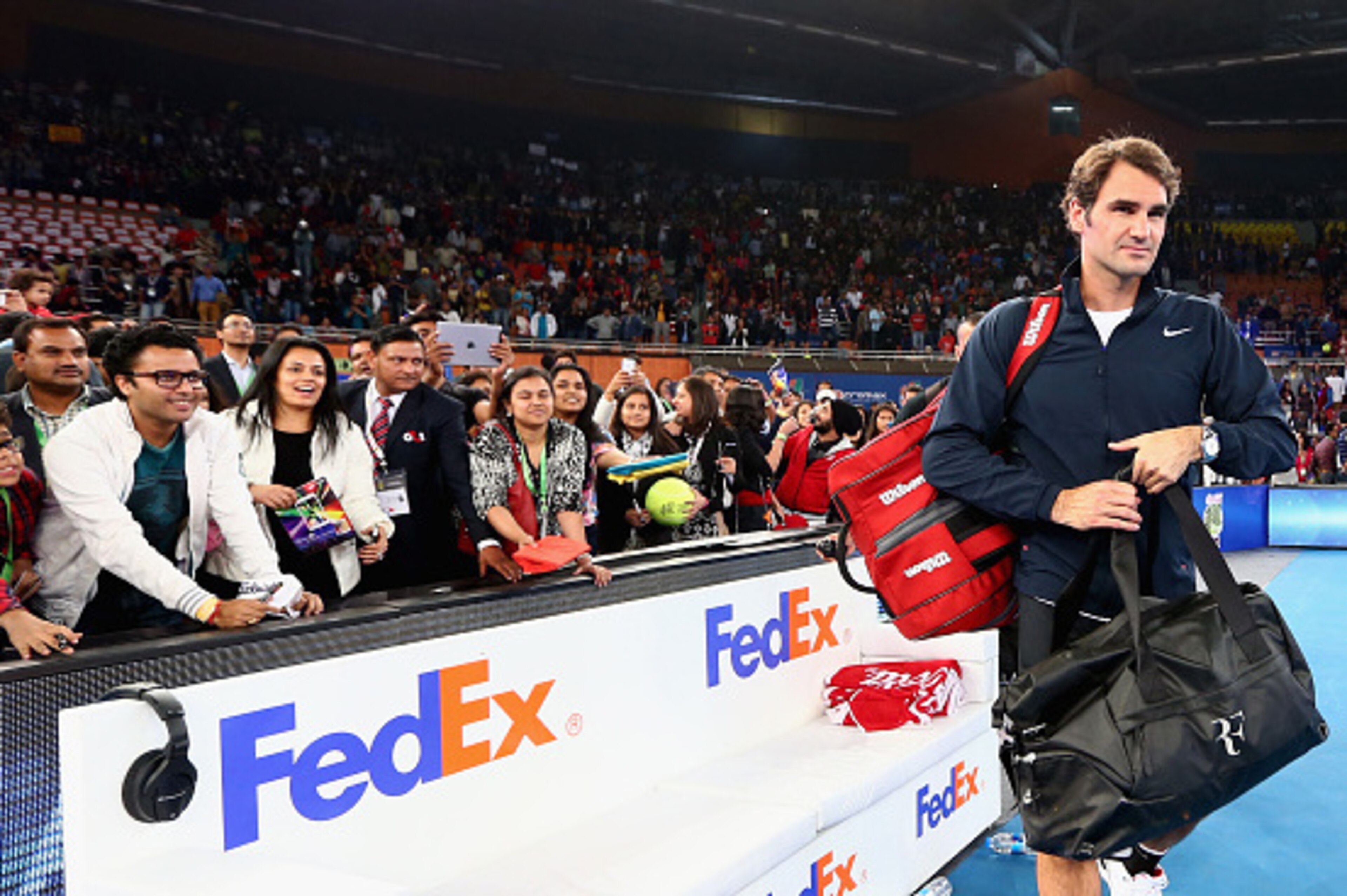 DELHI, INDIA - DECEMBER 07:  Roger Federer of the Indian Aces walks off the court after his victory in his match against Tomas Berdych  of the Singapore Slammers during the Coca-Cola International Premier Tennis League third leg at the Indira Gandhi Indoo