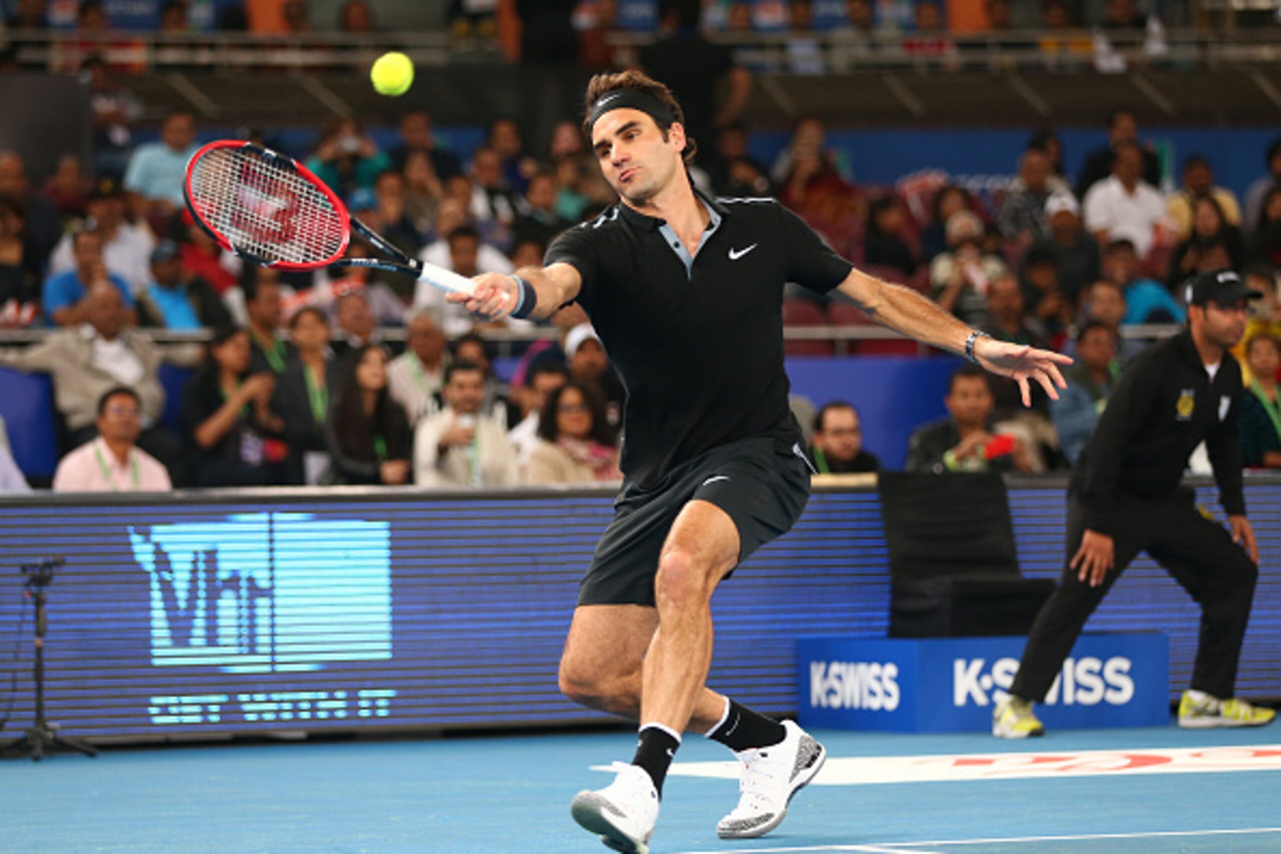 DELHI, INDIA - DECEMBER 07:  Roger Federer of the Indian Aces plays a forehand against Tomas Berdych  of the Singapore Slammers during the Coca-Cola International Premier Tennis League third leg at the Indira Gandhi Indoor Stadium December 7, 2014 in Delh