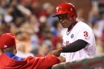Sep 26, 2014; Philadelphia, PA, USA; Philadelphia Phillies right fielder Marlon Byrd (3) scores a run in the sixth and is congratulated as he heads back to the dugout in a game against the Atlanta Braves at Citizens Bank Park. The Phillies defeated the Br