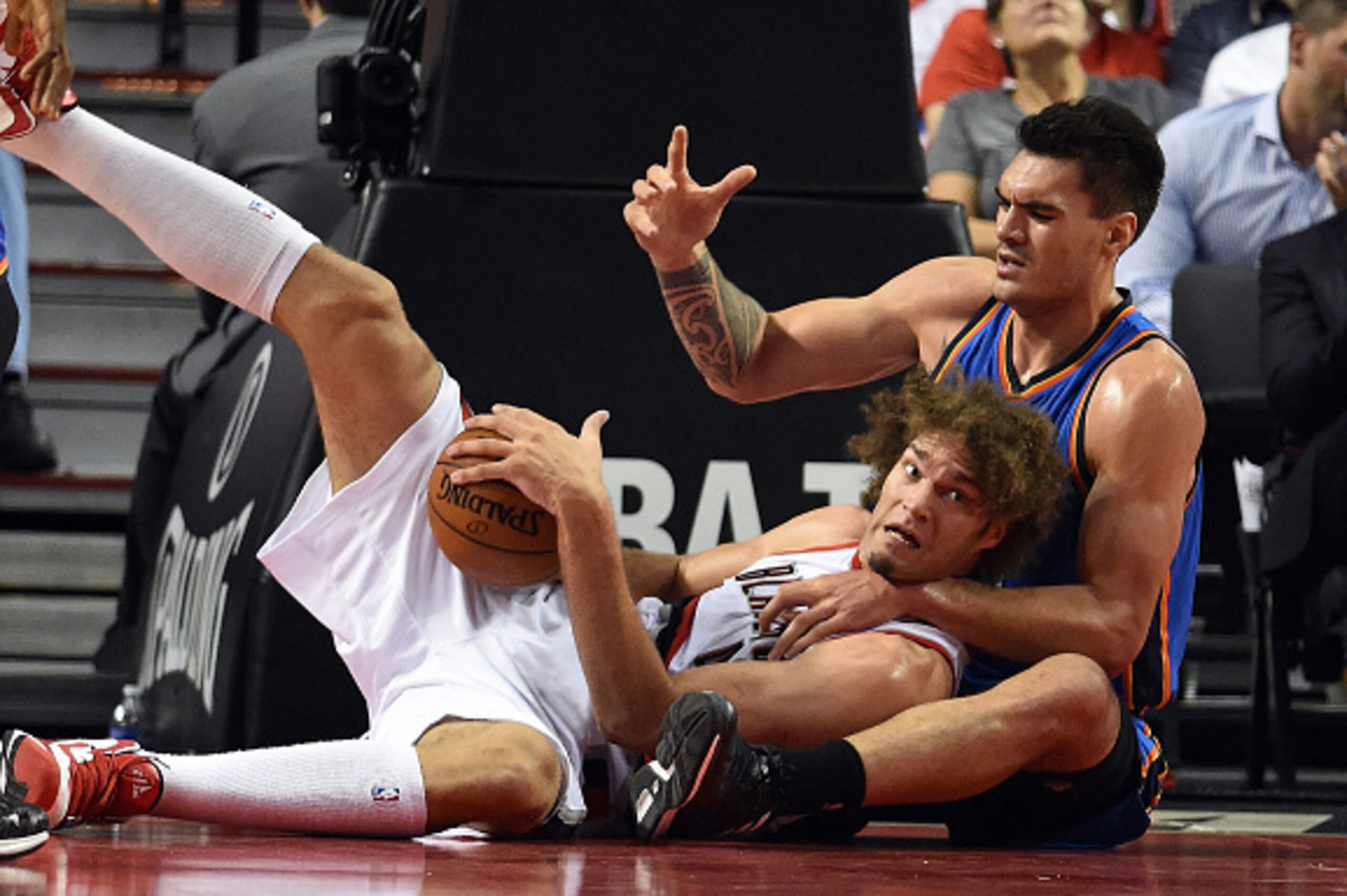 PORTLAND, OR - OCTOBER 29: Robin Lopez #42 of the Portland Trail Blazers and  Steven Adams #12 of the Oklahoma City Thunder scramble for a loose ball during the second quarter of the game at Moda Center on October 29, 2014 in Portland, Oregon.  NOTE TO US