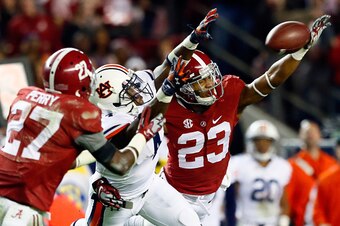 TUSCALOOSA, AL - NOVEMBER 29:  Nick Perry #27 of the Alabama Crimson Tide intercepts a pass intended for Quan Bray #4 of the Auburn Tigers thrown by Nick Marshall #14 in the fourth quarter during the Iron Bowl at Bryant-Denny Stadium on November 29, 2014 