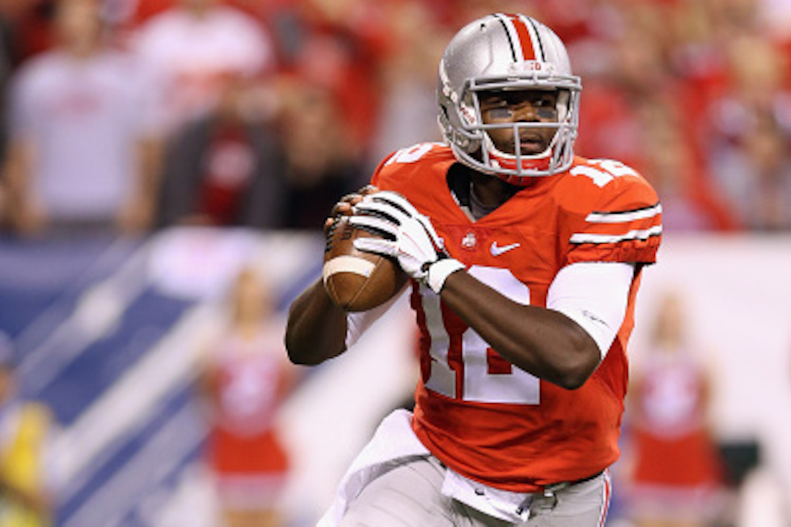 INDIANAPOLIS, IN - DECEMBER 06:  Quarterback Cardale Jones #12 of the Ohio State Buckeyes sets up in the pocket during the first quarter against the Wisconsin Badgers in the Big Ten Championship at Lucas Oil Stadium on December 6, 2014 in Indianapolis, In