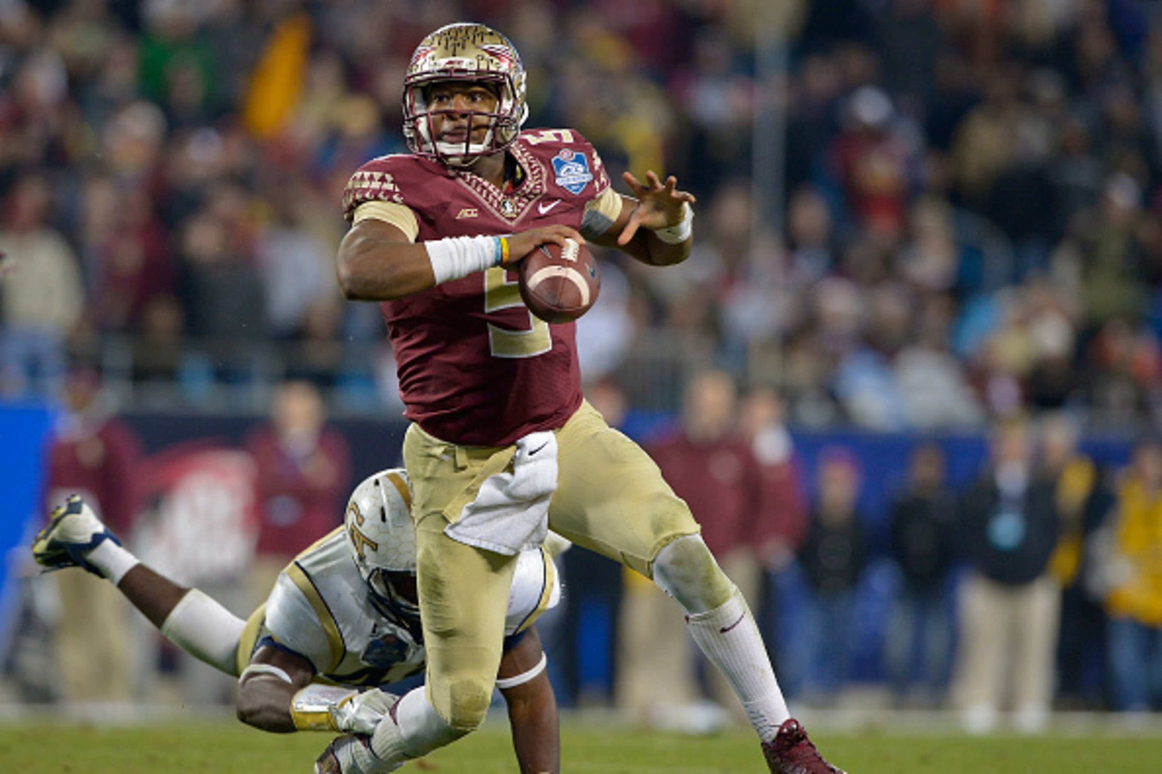 CHARLOTTE, NC - DECEMBER 06: Jameis Winston #5 of the Florida State Seminoles avoids a sack by Shaun Kagawa #44 of the Georgia Tech Yellow Jackets during the Atlantic Coast Conference championship game on December 6, 2014 in Greenville, North Carolina. F CHARLOTTE, NC - DECEMBER 06: Jameis Winston #5 of the Florida State Seminoles avoids a sack by Shaun Kagawa #44 of the Georgia Tech Yellow Jackets during the Atlantic Coast Conference championship game on December 6, 2014 in Greenville, North Carolina. F