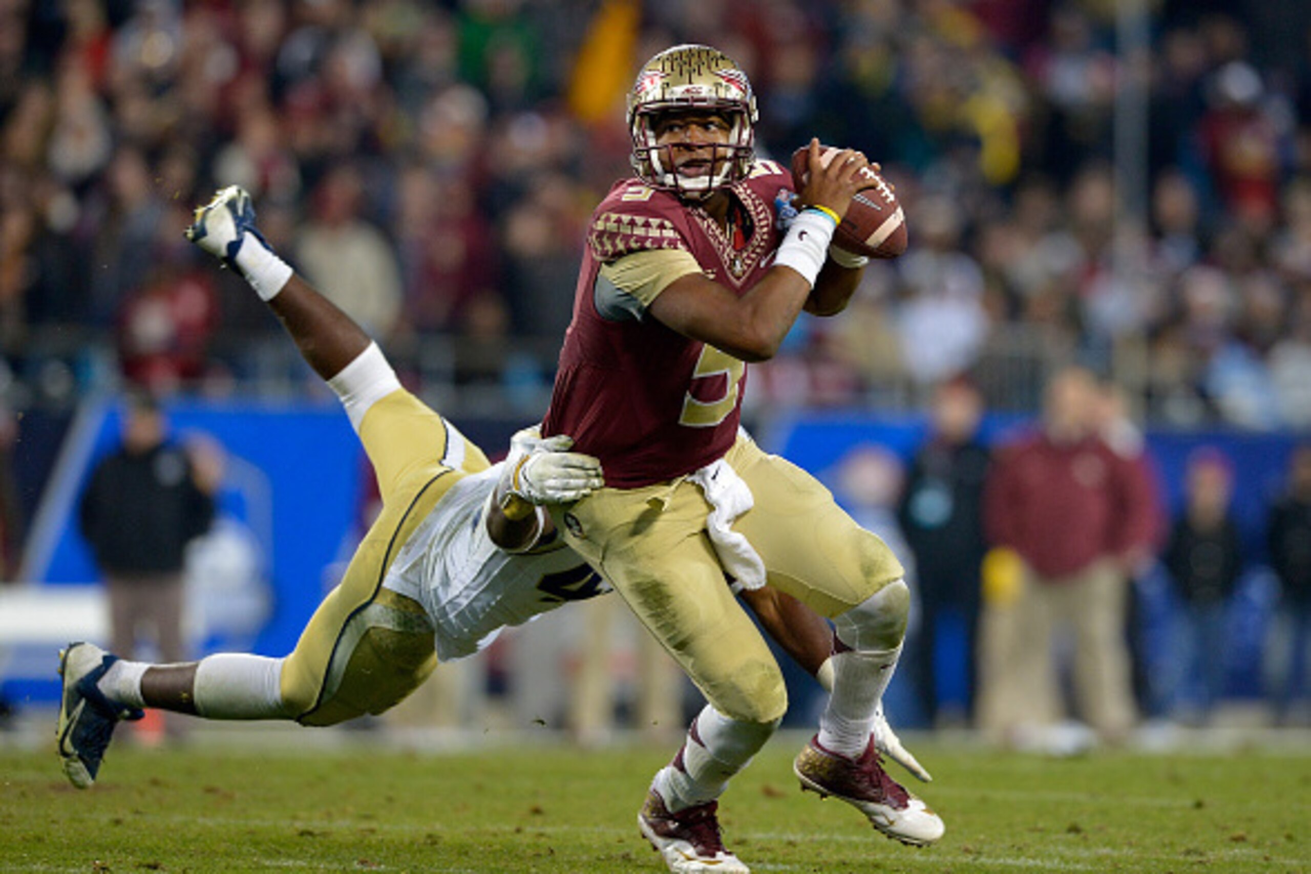 CHARLOTTE, NC - DECEMBER 06: Jameis Winston #5 of the Florida State Seminoles avoids a sack by Shaun Kagawa #44 of the Georgia Tech Yellow Jackets during the Atlantic Coast Conference championship game on December 6, 2014 in Greenville, North Carolina. F CHARLOTTE, NC - DECEMBER 06: Jameis Winston #5 of the Florida State Seminoles avoids a sack by Shaun Kagawa #44 of the Georgia Tech Yellow Jackets during the Atlantic Coast Conference championship game on December 6, 2014 in Greenville, North Carolina. F