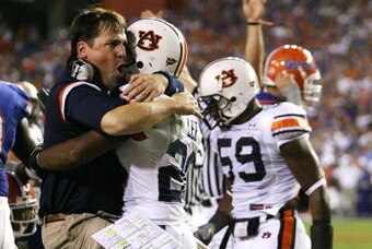 GAINESVILLE, FL - SEPTEMBER 29:  Defensive coordinator Will Muschamp of the Auburn Tigers jumps into the arms of defensive back Patrick Lee #20 after Lee helped cause a fumble late in the first half against the Florida Gators at Ben Hill Griffin Stadium S