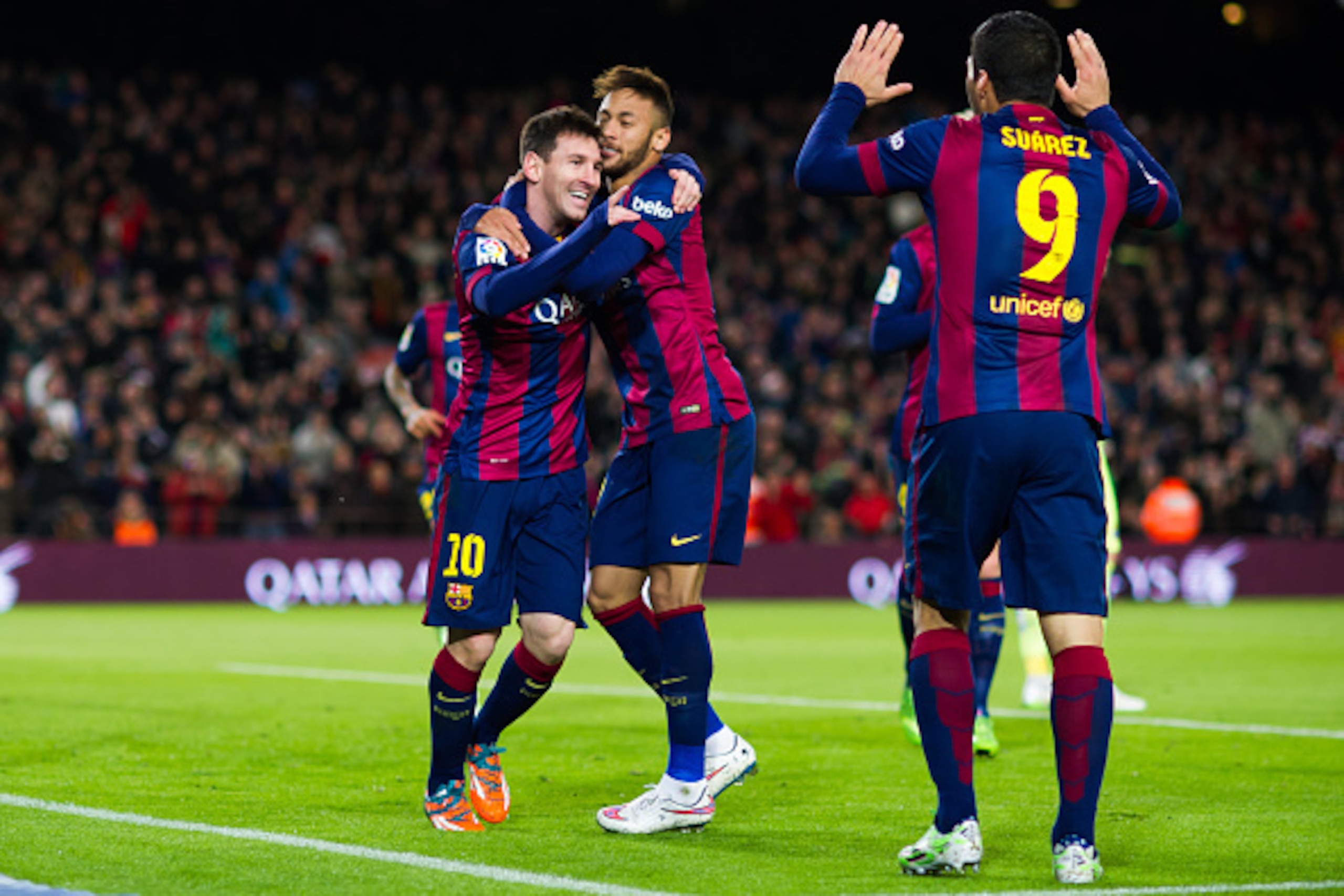 BARCELONA, SPAIN - DECEMBER 07: Lionel Messi (L) of FC Barcelona celebrates with his teammates Neymar Santos Jr (C) and Luis Suarez (R) after scoring his second team's goal during the La Liga match between FC Barcelona and RCD Espanyol at Camp Nou on Dece