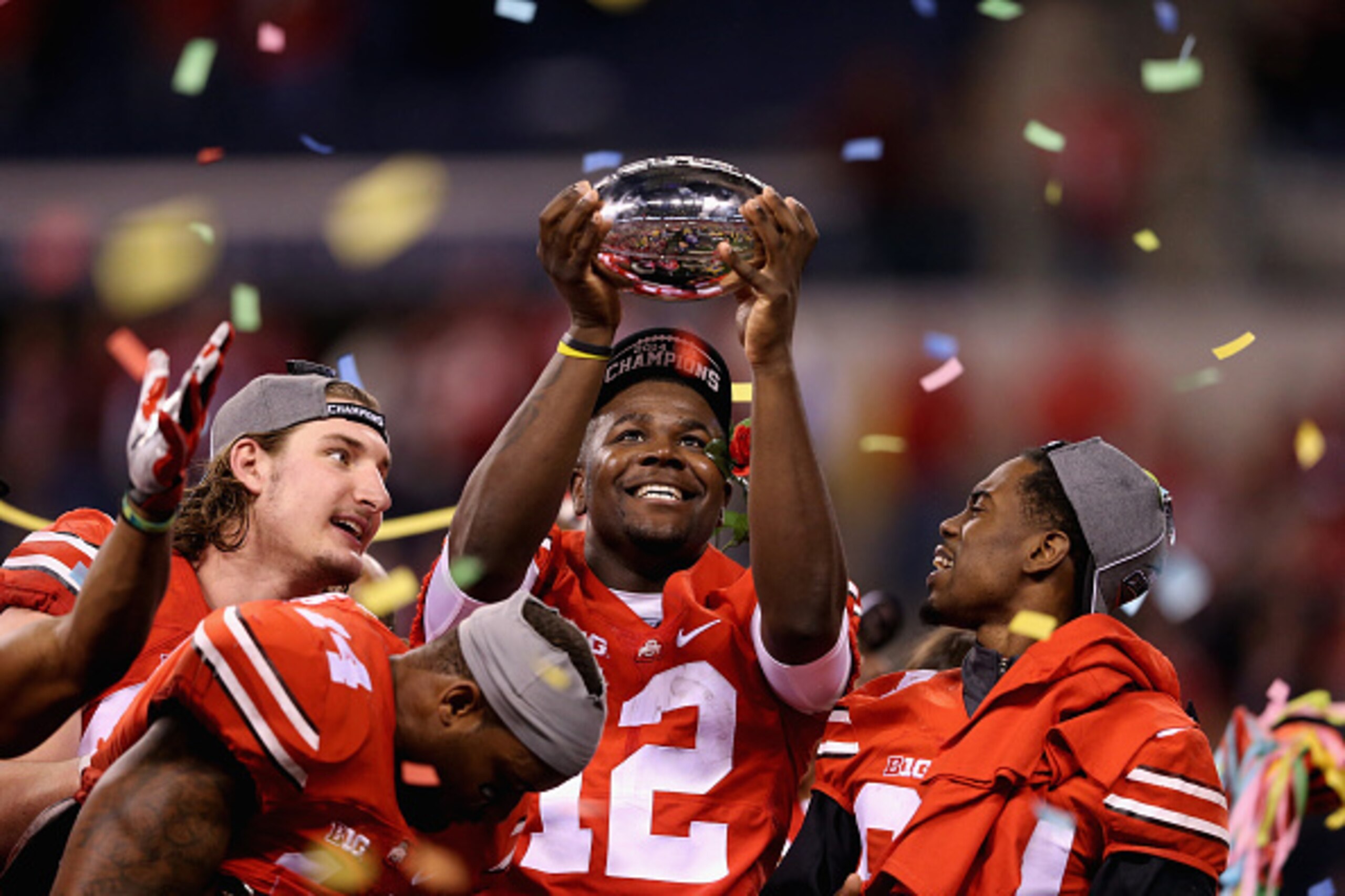 INDIANAPOLIS, IN - DECEMBER 06: Quarterback Cardale Jones #12 of the Ohio State Buckeyes lifts the Big Ten trophy after his team defeeated the Wisconsin Badgers 59-0 in the Big Ten Championship at Lucas Oil Stadium on December 6, 2014 in Indianapolis, In INDIANAPOLIS, IN - DECEMBER 06: Quarterback Cardale Jones #12 of the Ohio State Buckeyes lifts the Big Ten trophy after his team defeeated the Wisconsin Badgers 59-0 in the Big Ten Championship at Lucas Oil Stadium on December 6, 2014 in Indianapolis, In