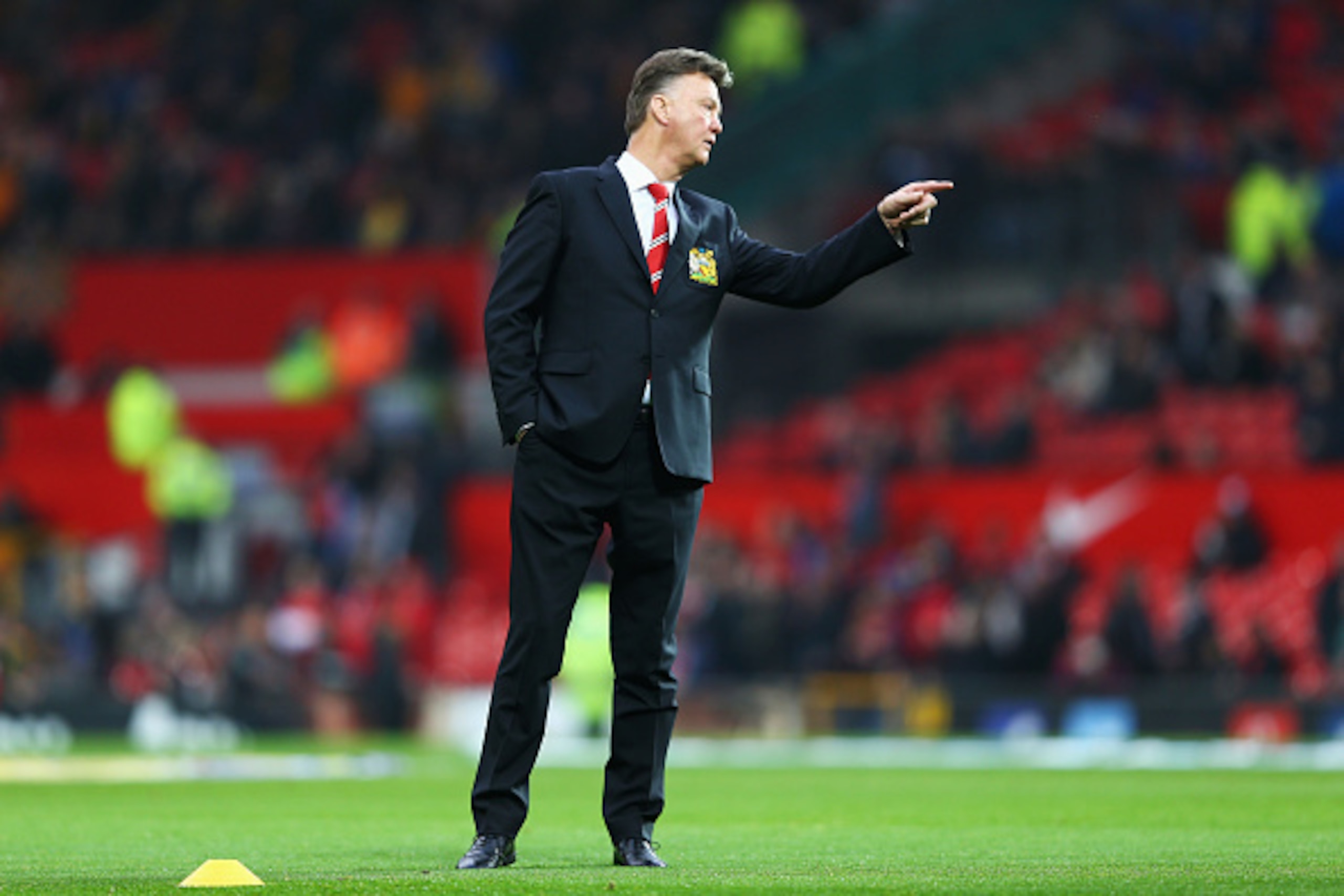 MANCHESTER, ENGLAND - NOVEMBER 29:  Louis van Gaal manager of Manchester United signals prior to the Barclays Premier League match between Manchester United and Hull City at Old Trafford on November 29, 2014 in Manchester, England.  (Photo by Clive Mason/