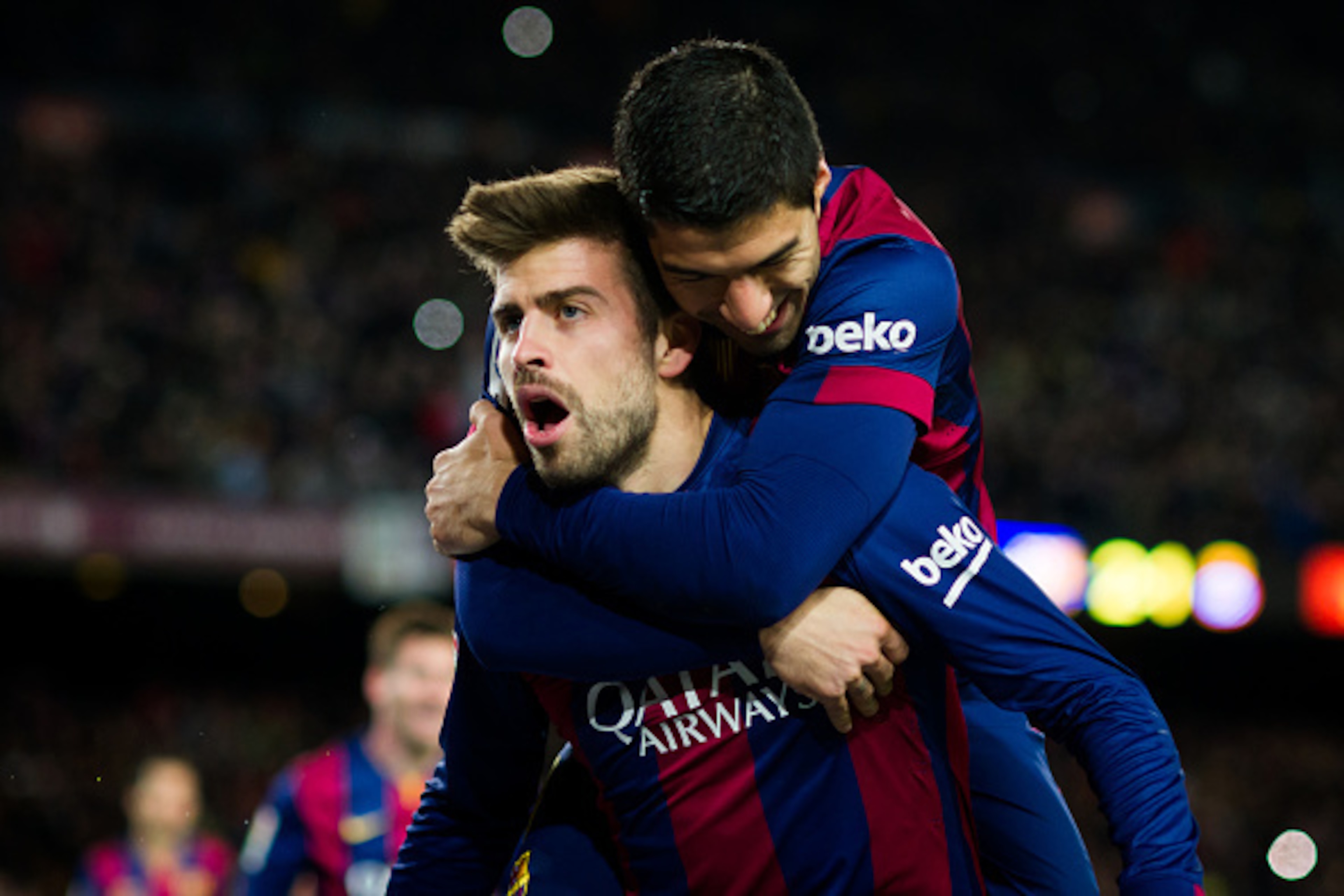 BARCELONA, SPAIN - DECEMBER 07: Gerard Pique (L) of FC Barcelona celebrates with his teammate Luis Suarez after scoring his team's third goal during the La Liga match between FC Barcelona and RCD Espanyol at Camp Nou on December 7, 2014 in Barcelona, Spai