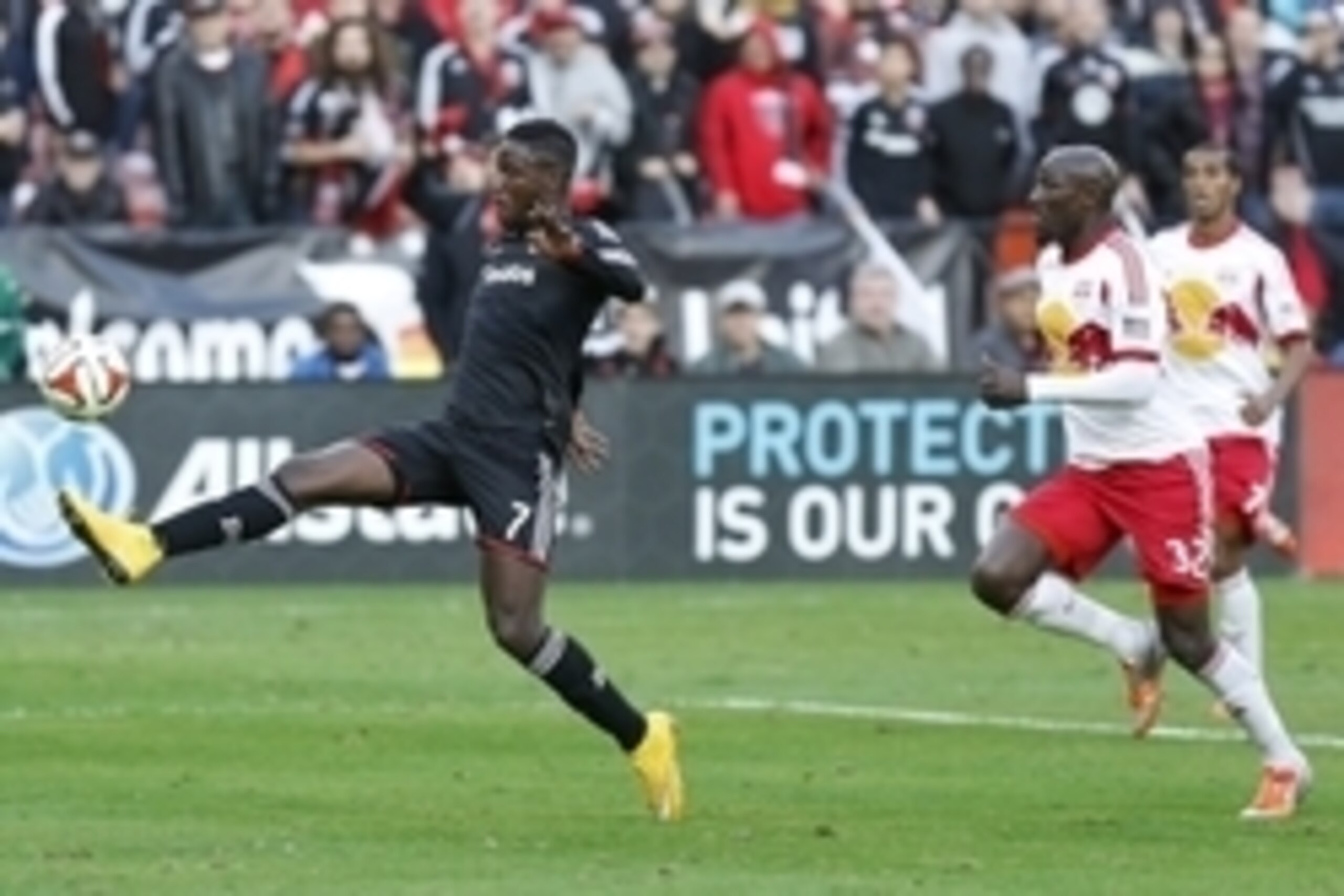 Nov 8, 2014; Washington, DC, USA; D.C. United forward Eddie Johnson (7) controls the ball as New York Red Bulls defender Ibrahim Sekagya (32) chases in the second half of leg 2 of the Eastern Conference semifinals in the 2014 MLS Cup Playoffs at Robert F.