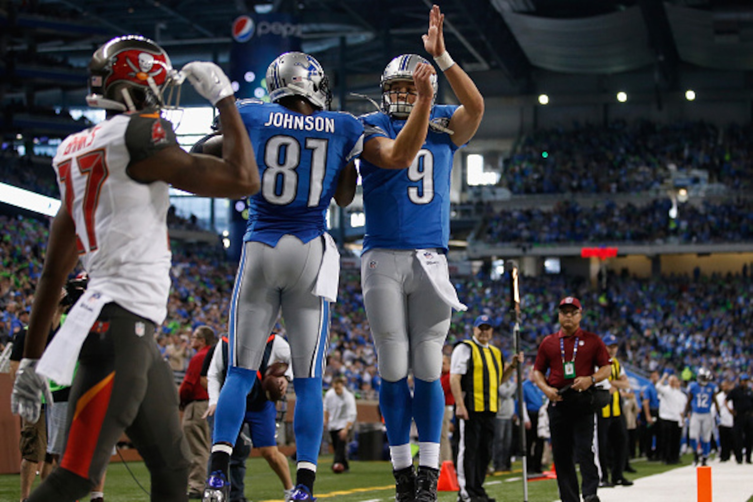 DETROIT, MI - DECEMBER 07: Calvin Johnson #81 celebrates his first quarter touch down with Matthew Stafford #9 of the Detroit Lions while playing the Tampa Bay Buccaneers at Ford Field on December 07, 2014 in Detroit, Michigan. (Photo by Gregory Shamus/Ge