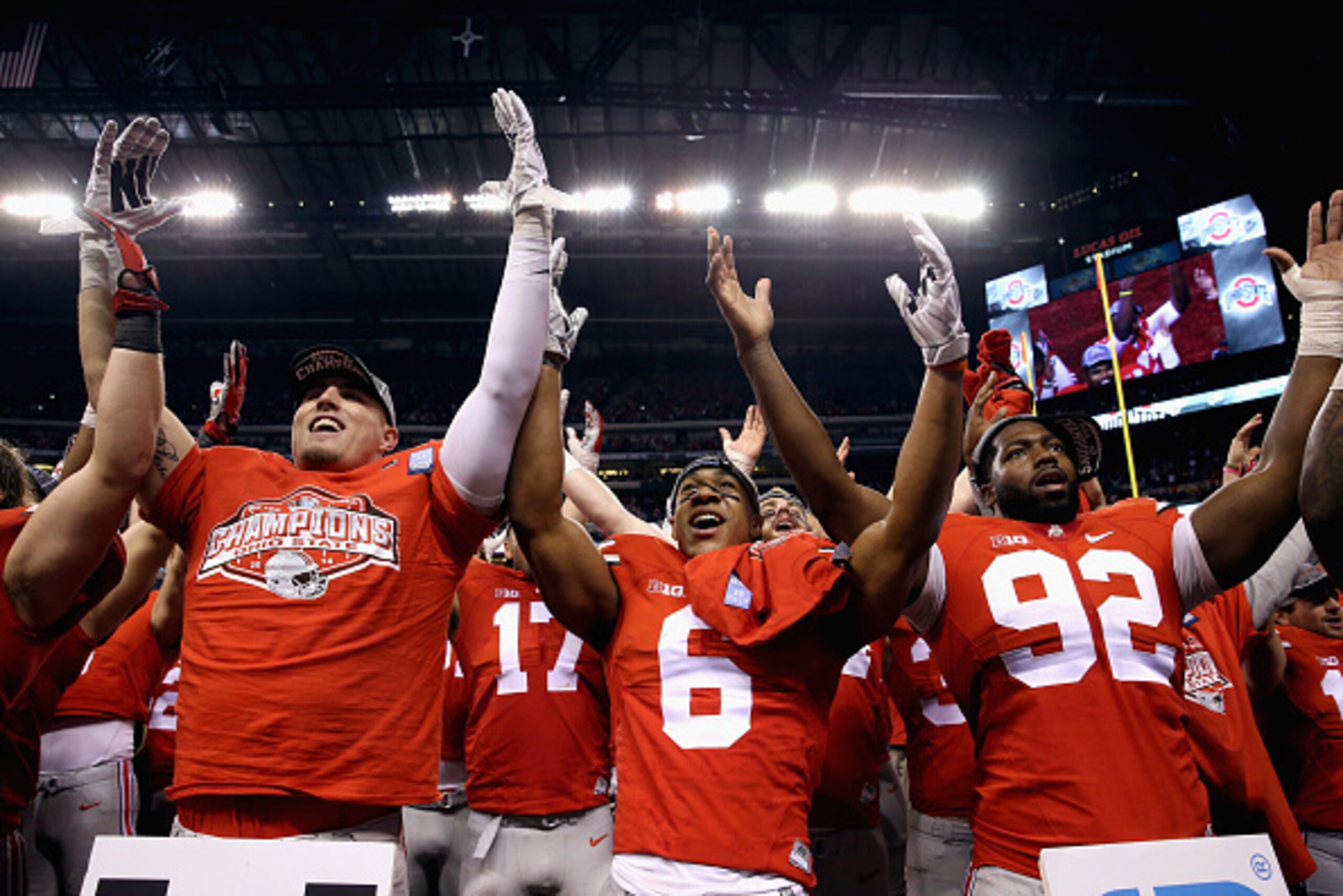 INDIANAPOLIS, IN - DECEMBER 06:  Evan Spencer #6 (C), Adolphus Washington #92 (R) and the Ohio State Buckeyes celebrate after they defeated the Wisconsin Badgers 59-0 in the Big Ten Championship at Lucas Oil Stadium on December 6, 2014 in Indianapolis, In