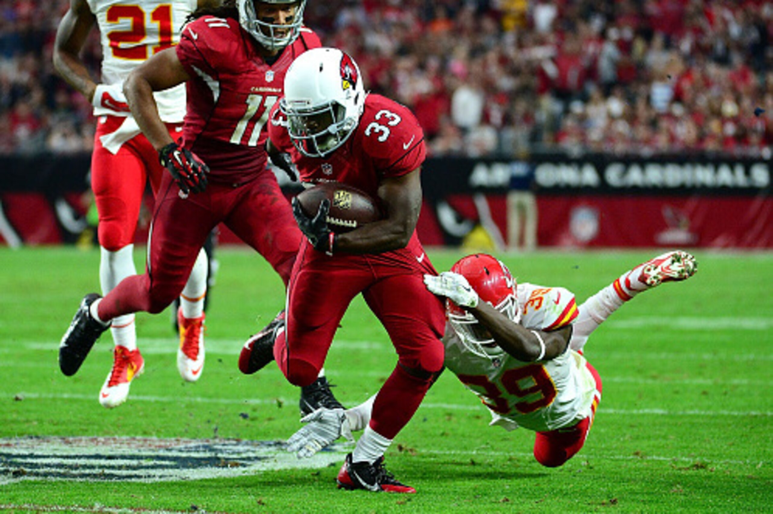 GLENDALE, AZ - DECEMBER 07: Running back Kerwynn Williams #33 of the Arizona Cardinals slips by free safety Husain Abdullah #39 of the Kansas City Chiefs in the second half of the the NFL game at University of Phoenix Stadium on December 7, 2014 in Glenda