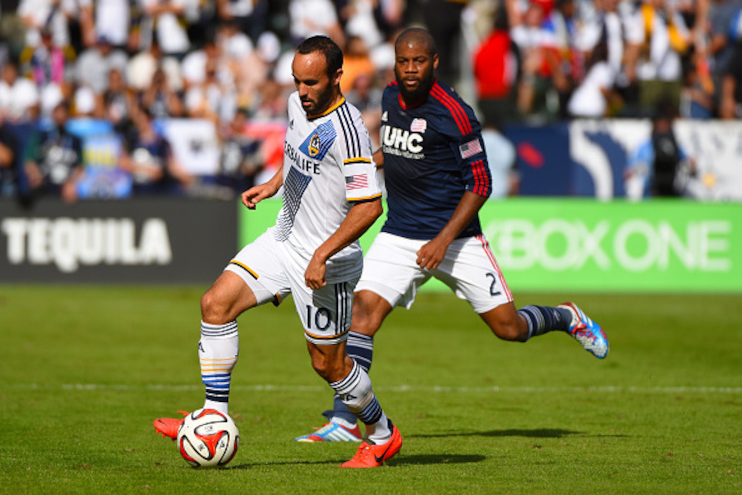 LOS ANGELES, CA - DECEMBER 07:  Landon Donovan of the Los Angeles Galaxy plays against Andrew Farrell of the New England Revolution during the 2014 MLS Cup match at the at StubHub Center on December 7, 2014 in Los Angeles, California.  (Photo by Victor De