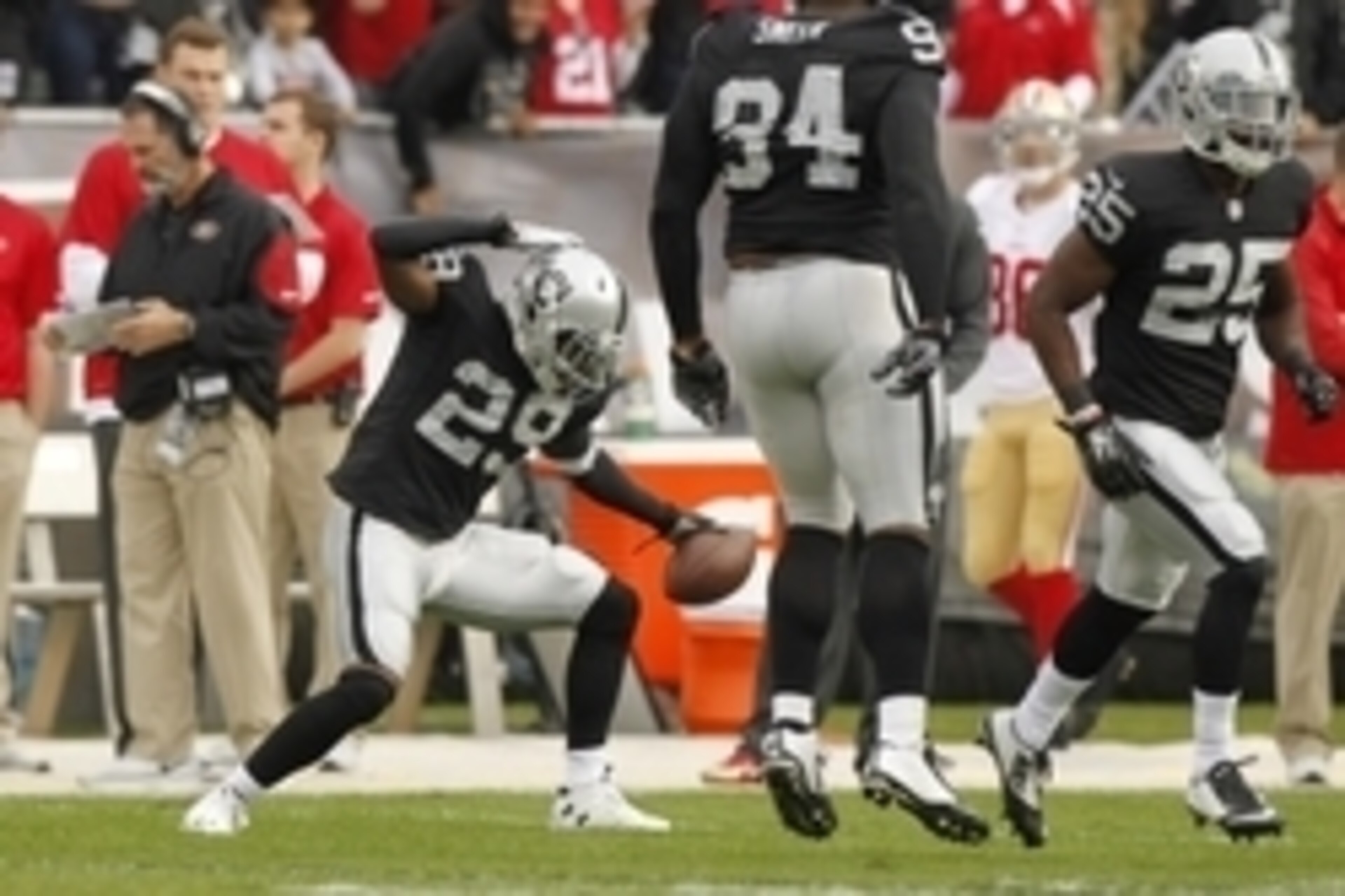 Dec 7, 2014; Oakland, CA, USA; Oakland Raiders strong safety Brandian Ross (29) reacts after intercepting a pass against the San Francisco 49ers in the first quarter at O.co Coliseum. Mandatory Credit: Cary Edmondson-USA TODAY Sports