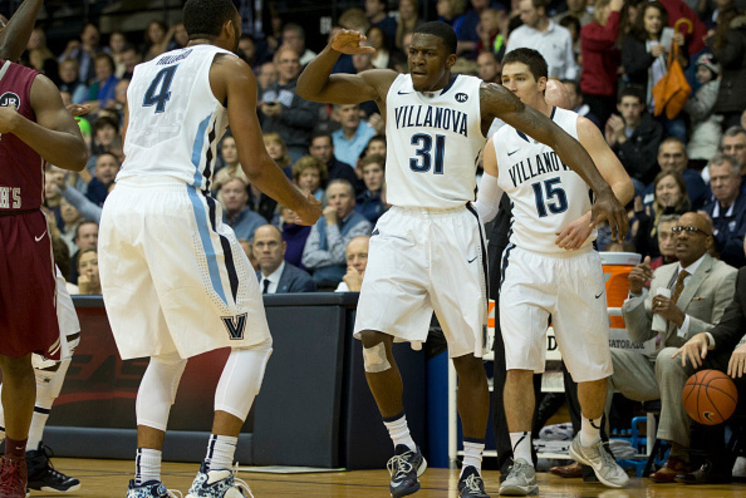 PHILADELPHIA, PA - DECEMBER 6: Dylan Ennis #31, Darrun Hilliard #4 and Ryan Arcidiacono #15 of the Villanova Wildcats react after Ennis threw the ball off of a Saint Joseph's Hawks player to gain possession of the ball on December 6, 2014 at the Pavilion 