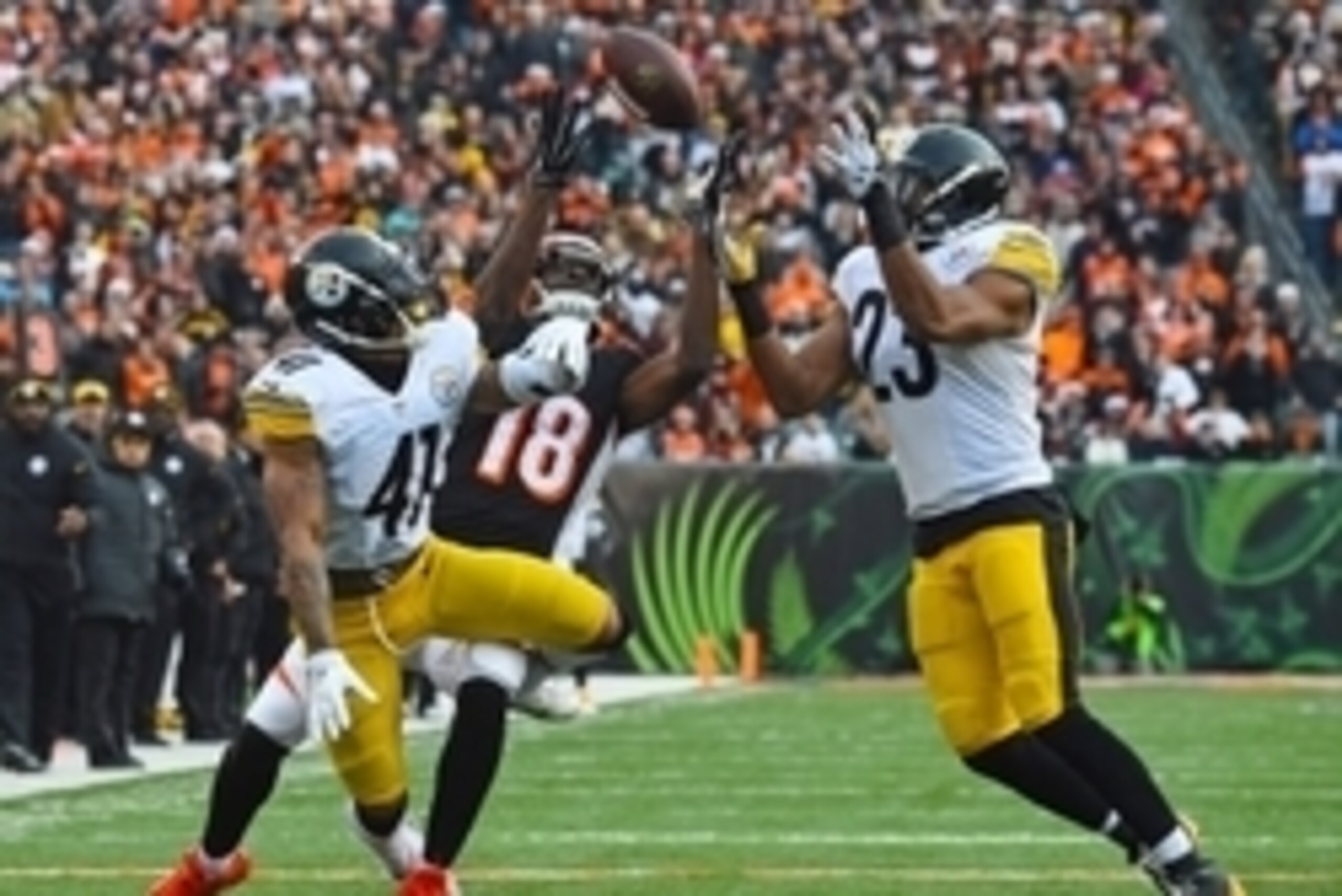 Dec 7, 2014; Cincinnati, OH, USA; Cincinnati Bengals wide receiver A.J. Green (18) attempts to make a catch against Pittsburgh Steelers defensive back Antwon Blake (41) and free safety Mike Mitchell (23) during the second half at Paul Brown Stadium. Pitts