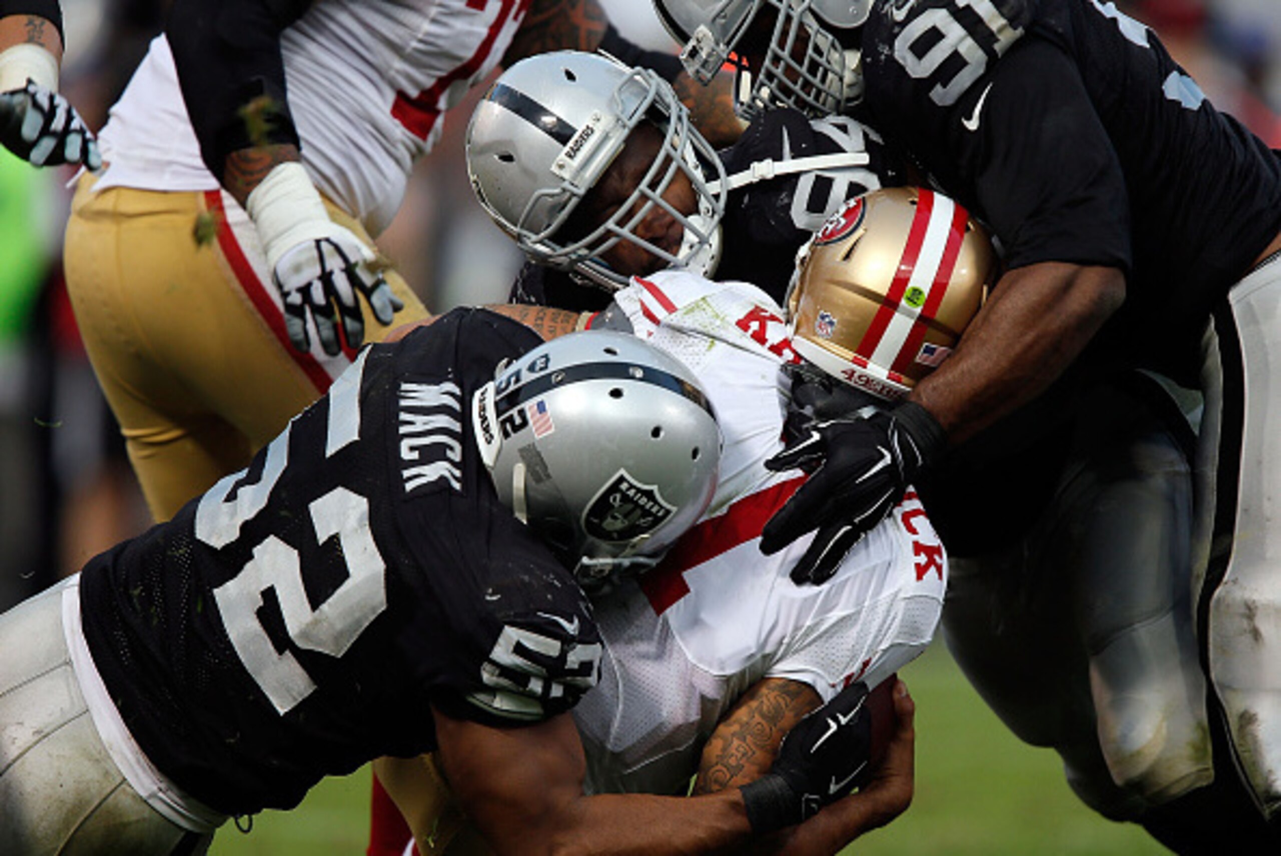OAKLAND, CA - DECEMBER 07: Justin Tuck #91 of the Oakland Raiders, Antonio Smith #94 of the Oakland Raiders, Khalil Mack #52 of the Oakland Raiders sack Colin Kaepernick #7 of the San Francisco 49ers in the fourth quarter at O.co Coliseum on December 7, OAKLAND, CA - DECEMBER 07: Justin Tuck #91 of the Oakland Raiders, Antonio Smith #94 of the Oakland Raiders, Khalil Mack #52 of the Oakland Raiders sack Colin Kaepernick #7 of the San Francisco 49ers in the fourth quarter at O.co Coliseum on December 7,