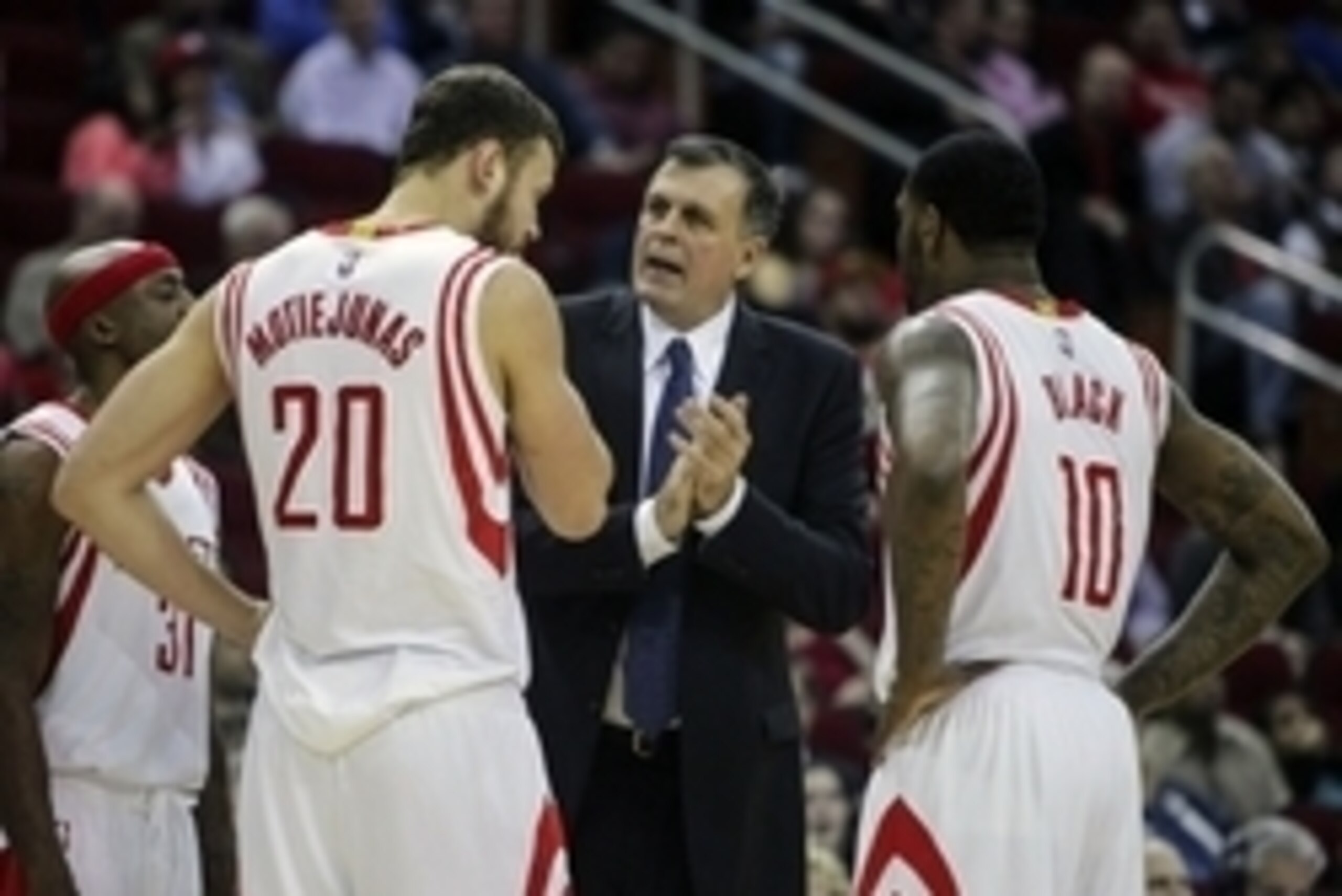 Dec 3, 2014; Houston, TX, USA; Houston Rockets head coach Kevin McHale talks with forward Donatas Motiejunas (20) and forward Tarik Black (10) during the first quarter against the Memphis Grizzlies at Toyota Center. Mandatory Credit: Troy Taormina-USA TOD