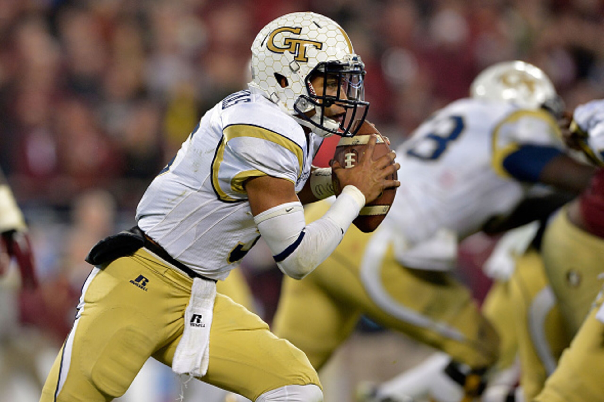 CHARLOTTE, NC - DECEMBER 06:  Justin Thomas #5 of the Georgia Tech Yellow Jackets runs the ball against the Florida State Seminoles in the 2nd half during the Atlantic Coast Conference championship game on December 6, 2014 in Greenville, North Carolina.  