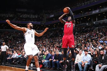 NEW YORK, NY - NOVEMBER 17:  James Ennis #32 of the Miami Heat shoots against Alan Anderson #6 of the Brooklyn Nets on November 17, 2014 at the Barclays Center in the Brooklyn borough of New York City. NOTE TO USER: User expressly acknowledges and agrees 