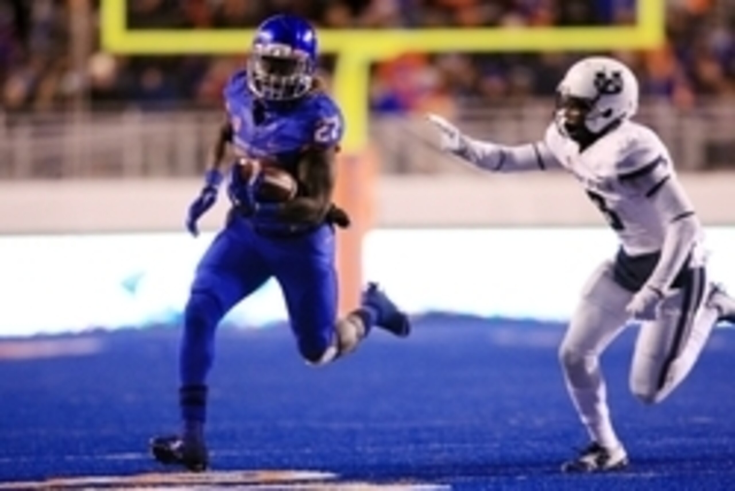 Nov 29, 2014; Boise, ID, USA; Boise State Broncos running back Jay Ajayi (27) runs away from Utah State Aggies cornerback Rashard Stewart (6) during the second half  at Albertsons Stadium. Boise State beats Utah State 50-19. Mandatory Credit: Brian Losnes