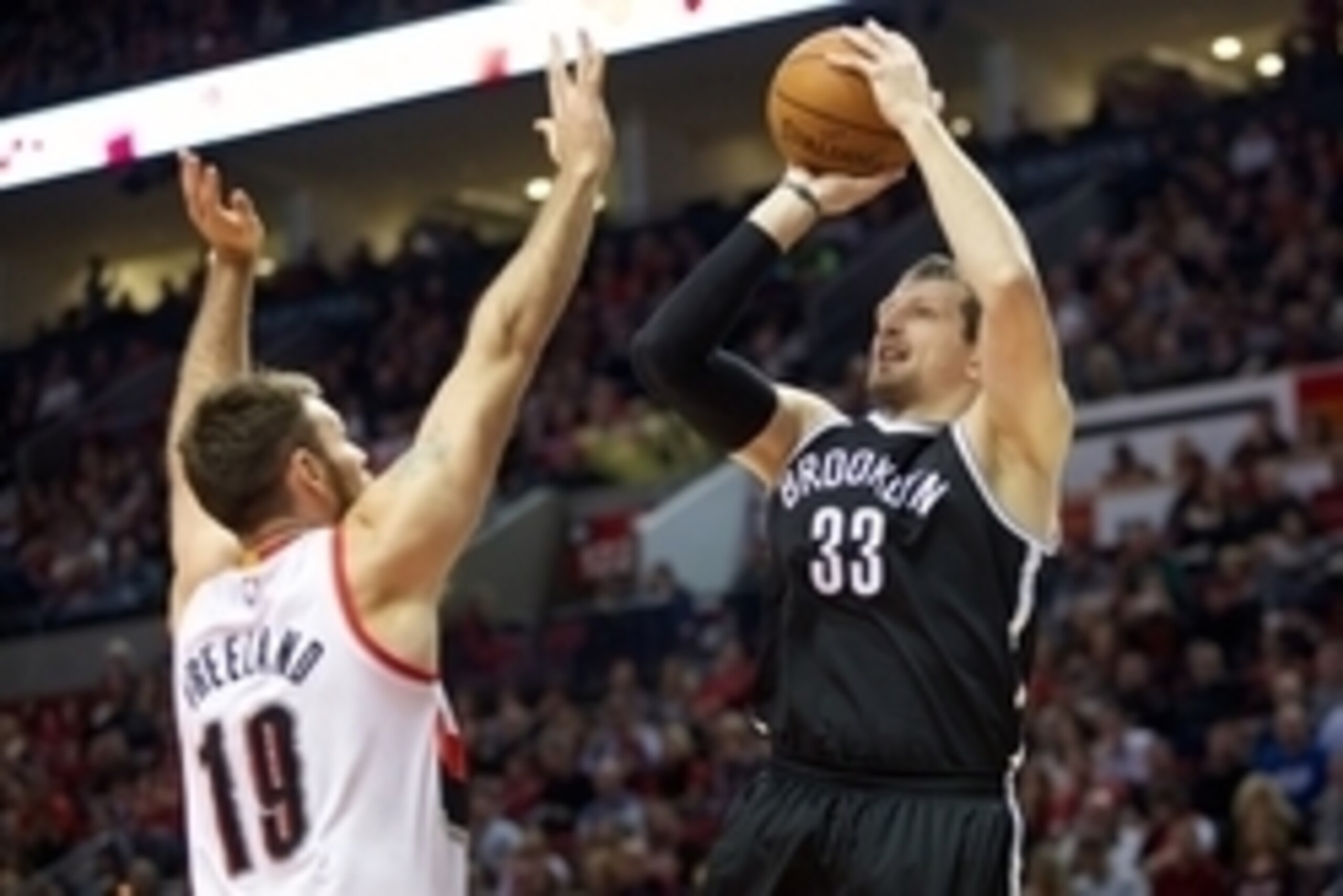 Nov 15, 2014; Portland, OR, USA; Brooklyn Nets forward Mirza Teletovic (33) shoots over Portland Trail Blazers center Joel Freeland (19) at Moda Center at the Rose Quarter. Mandatory Credit: Jaime Valdez-USA TODAY Sports